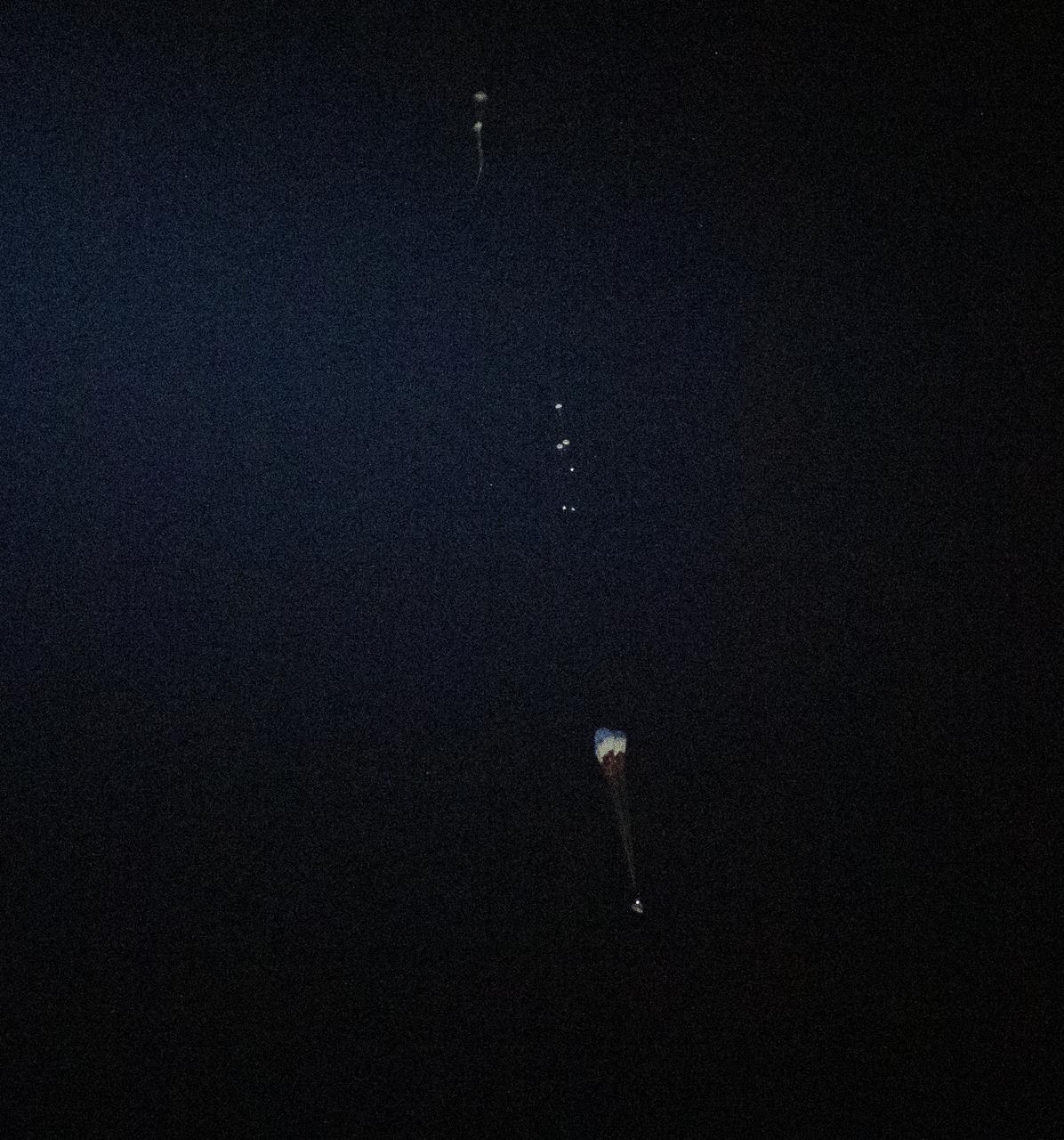 The main parachutes begin to deploy as the Boeing CST-100 Starliner spacecraft lands in White Sands, New Mexico, Sunday, Dec. 22, 2019. The landing completes an abbreviated Orbital Flight Test for the company that still meets several mission objectives for NASA’s Commercial Crew program. The Starliner spacecraft launched on a United Launch Alliance Atlas V rocket at 6:36 a.m. Friday, Dec. 20 from Space Launch Complex 41 at Cape Canaveral Air Force Station in Florida. Photo Credit: (NASA/Bill Ingalls)