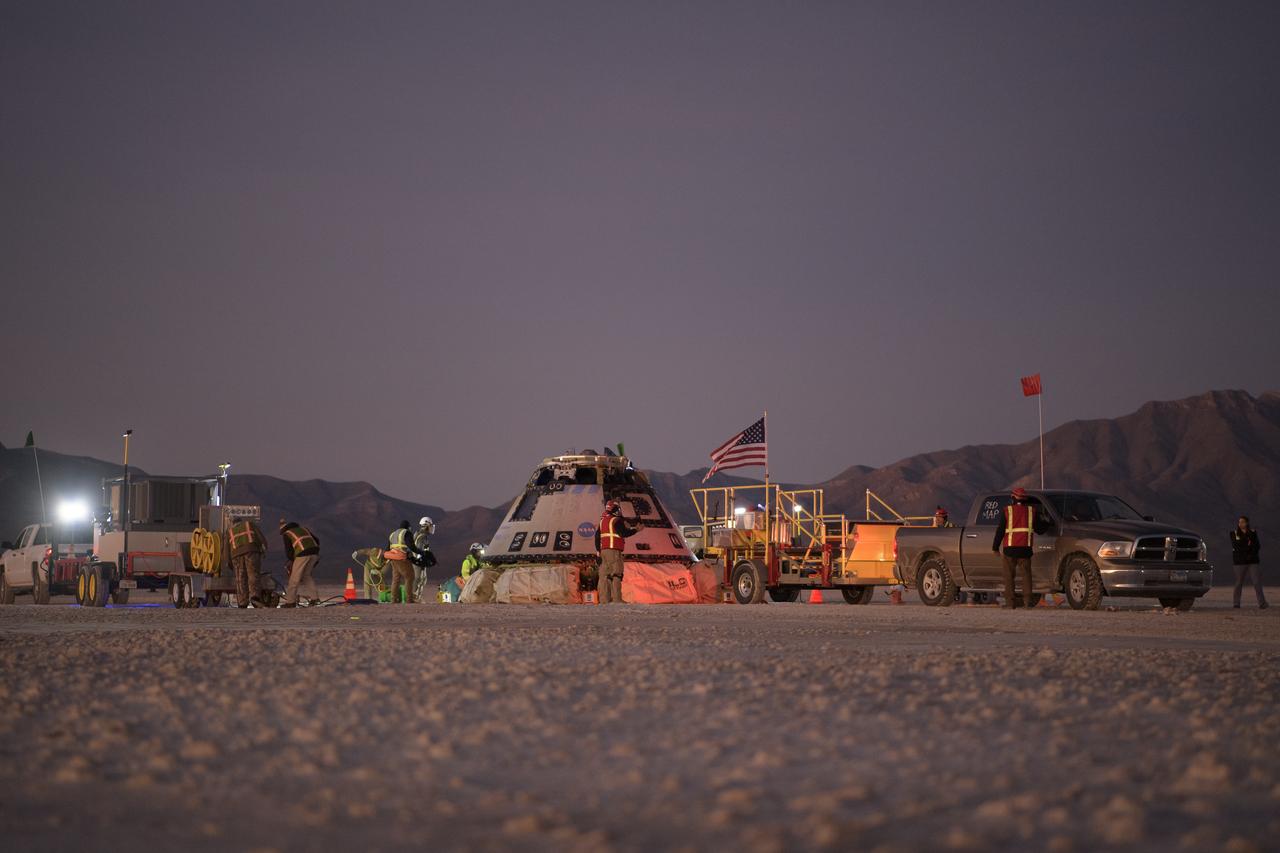 Boeing, NASA, and U.S. Army personnel work around the Boeing CST-100 Starliner spacecraft shortly after it landed in White Sands, New Mexico, Sunday, Dec. 22, 2019. The landing completes an abbreviated Orbital Flight Test for the company that still meets several mission objectives for NASA’s Commercial Crew program. The Starliner spacecraft launched on a United Launch Alliance Atlas V rocket at 6:36 a.m. Friday, Dec. 20 from Space Launch Complex 41 at Cape Canaveral Air Force Station in Florida. Photo Credit: (NASA/Bill Ingalls)
