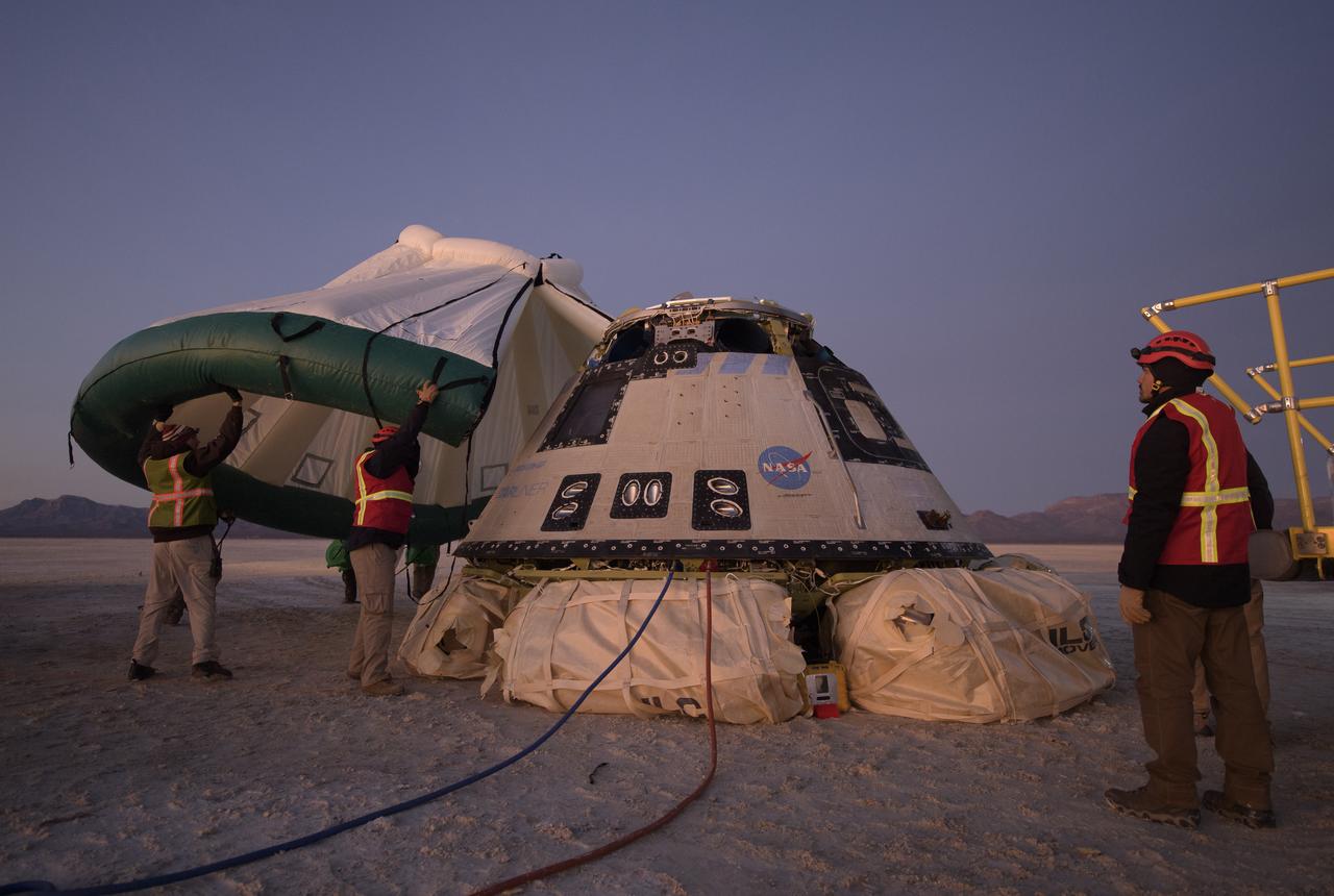 Boeing, NASA, and U.S. Army personnel work around the Boeing CST-100 Starliner spacecraft shortly after it landed in White Sands, New Mexico, Sunday, Dec. 22, 2019. The landing completes an abbreviated Orbital Flight Test for the company that still meets several mission objectives for NASA’s Commercial Crew program. The Starliner spacecraft launched on a United Launch Alliance Atlas V rocket at 6:36 a.m. Friday, Dec. 20 from Space Launch Complex 41 at Cape Canaveral Air Force Station in Florida. Photo Credit: (NASA/Bill Ingalls)
