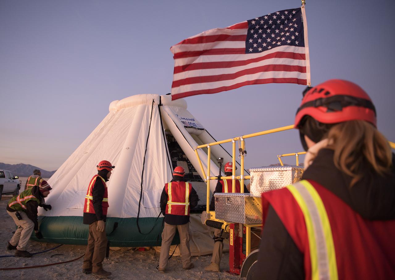 Boeing, NASA, and U.S. Army personnel work around the Boeing CST-100 Starliner spacecraft shortly after it landed in White Sands, New Mexico, Sunday, Dec. 22, 2019. The landing completes an abbreviated Orbital Flight Test for the company that still meets several mission objectives for NASA’s Commercial Crew program. The Starliner spacecraft launched on a United Launch Alliance Atlas V rocket at 6:36 a.m. Friday, Dec. 20 from Space Launch Complex 41 at Cape Canaveral Air Force Station in Florida. Photo Credit: (NASA/Bill Ingalls)