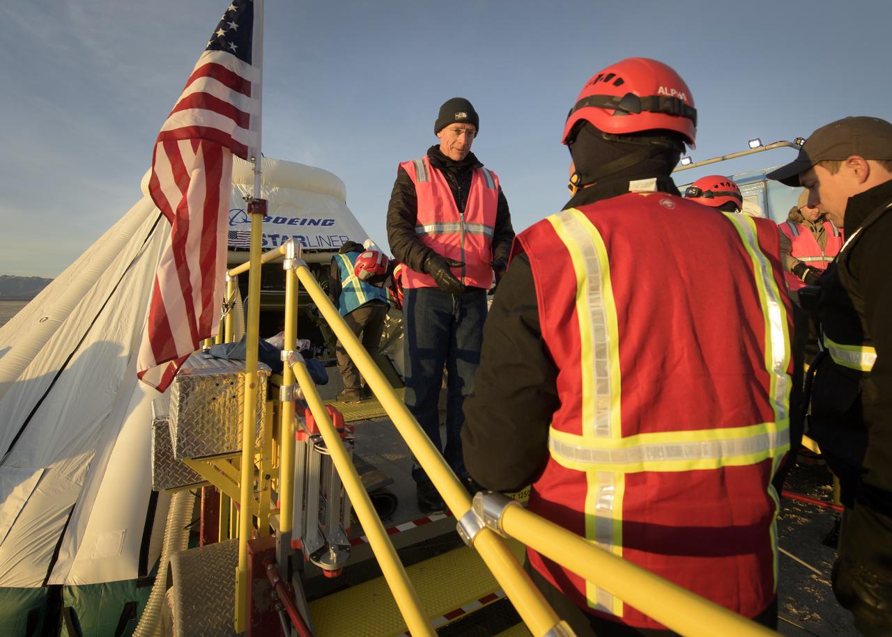 Boeing astronaut Chris Ferguson, talks with support personnel outside of the Boeing CST-100 Starliner spacecraft shortly after it landed in White Sands, New Mexico, Sunday, Dec. 22, 2019. The landing completes an abbreviated Orbital Flight Test for the company that still meets several mission objectives for NASA’s Commercial Crew program. The Starliner spacecraft launched on a United Launch Alliance Atlas V rocket at 6:36 a.m. Friday, Dec. 20 from Space Launch Complex 41 at Cape Canaveral Air Force Station in Florida. Photo Credit: (NASA/Bill Ingalls)