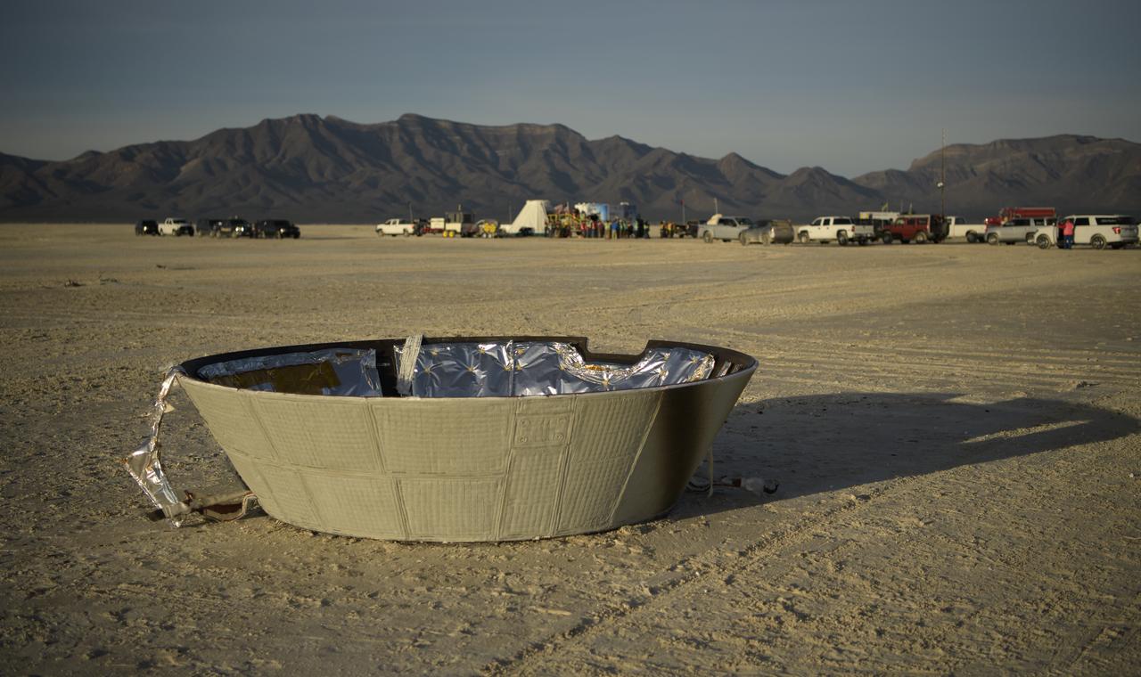 The forward heat shield is seen in the foreground of the Boeing CST-100 Starliner spacecraft landing zone shortly after the landing in White Sands, New Mexico, Sunday, Dec. 22, 2019. The landing completes an abbreviated Orbital Flight Test for the company that still meets several mission objectives for NASA’s Commercial Crew program. The Starliner spacecraft launched on a United Launch Alliance Atlas V rocket at 6:36 a.m. Friday, Dec. 20 from Space Launch Complex 41 at Cape Canaveral Air Force Station in Florida. Photo Credit: (NASA/Bill Ingalls)