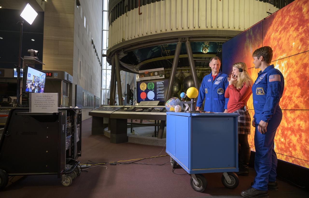 NASA astronauts Nick Hague, left, and Anne McClain, right, join Bevin James of the Smithsonian Air and Space Museum as she hosts an interactive video teleconference with 5th graders at the John P Parker school located in Cincinnati, Ohio, Tuesday, Jan. 14, 2020, from the Smithsonian National Air and Space Museum in Washington. Hague most recently spent 203 days living and working onboard the International Space Station as part of Expeditions 59 and 60. McClain most recently spent 204 days living and working onboard the International Space Station as part of Expeditions 58 and 59. Photo Credit: (NASA/Bill Ingalls)
