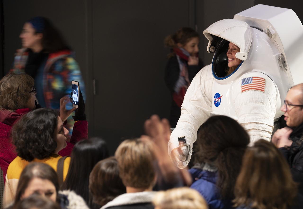 Attendees of the National Symphony Orchestra’s performance of Gustav Holst’s “The Planets” take pictures in a model of a spacesuit, Wednesday, Jan. 22, 2020, at The Anthem in Washington, DC. Photo Credit: (NASA/Joel Kowsky)