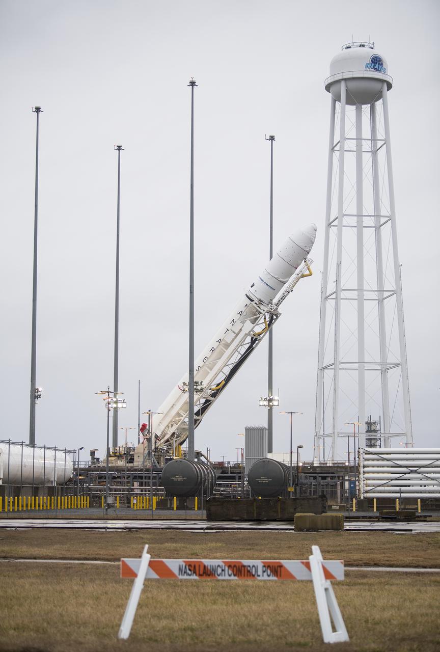 A Northrop Grumman Antares rocket carrying a Cygnus resupply spacecraft is raised into a vertical position on Pad-0A, Wednesday, Feb. 5, 2020, at NASA's Wallops Flight Facility in Virginia. Northrop Grumman’s 13th contracted cargo resupply mission with NASA to the International Space Station will deliver about 8,000 pounds of science and research, crew supplies and vehicle hardware to the orbital laboratory and its crew. The CRS-13 Cygnus spacecraft is named after the first African American astronaut, Major Robert Henry Lawrence Jr., and is scheduled to launch at 5:39pm EST Sunday, Feb. 9. Photo Credit: (NASA/Aubrey Gemignani)