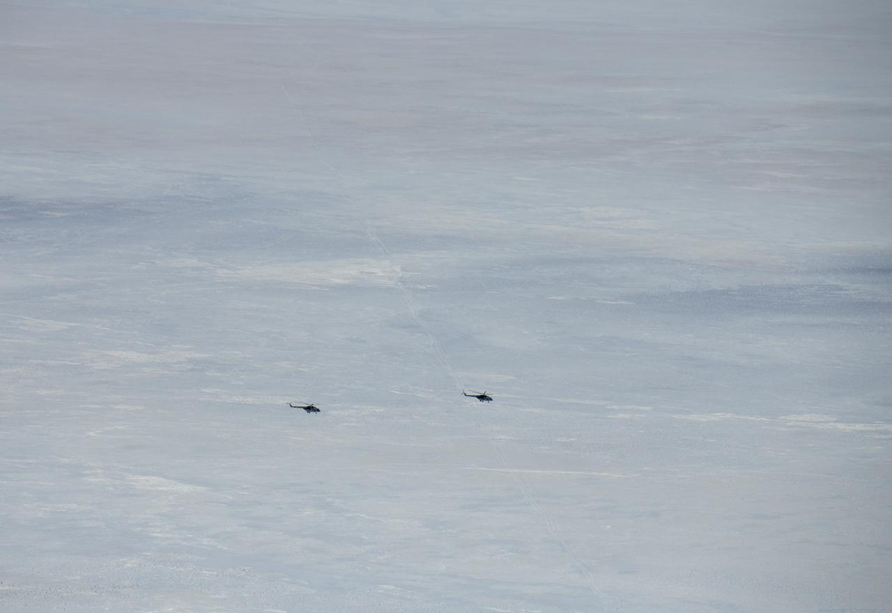 Russian MI-8 helicopters fly around the predicted landing zone of the Expedition 61 crew’s Soyuz MS-13 spacecraft near the town of Zhezkazgan, Kazakhstan Thursday, Feb. 6, 2020. Christina Koch returned to Earth after logging 328 days in space --- the longest spaceflight in history by a woman --- as a member of Expeditions 59-60-61 on the International Space Station. Roscosmos cosmonaut Alexander Skvortsov and ESA astronaut Luca Parmitano returned after 201 days in space where they served as Expedition 60-61 crew members onboard the station. Photo Credit: (NASA/Bill Ingalls)