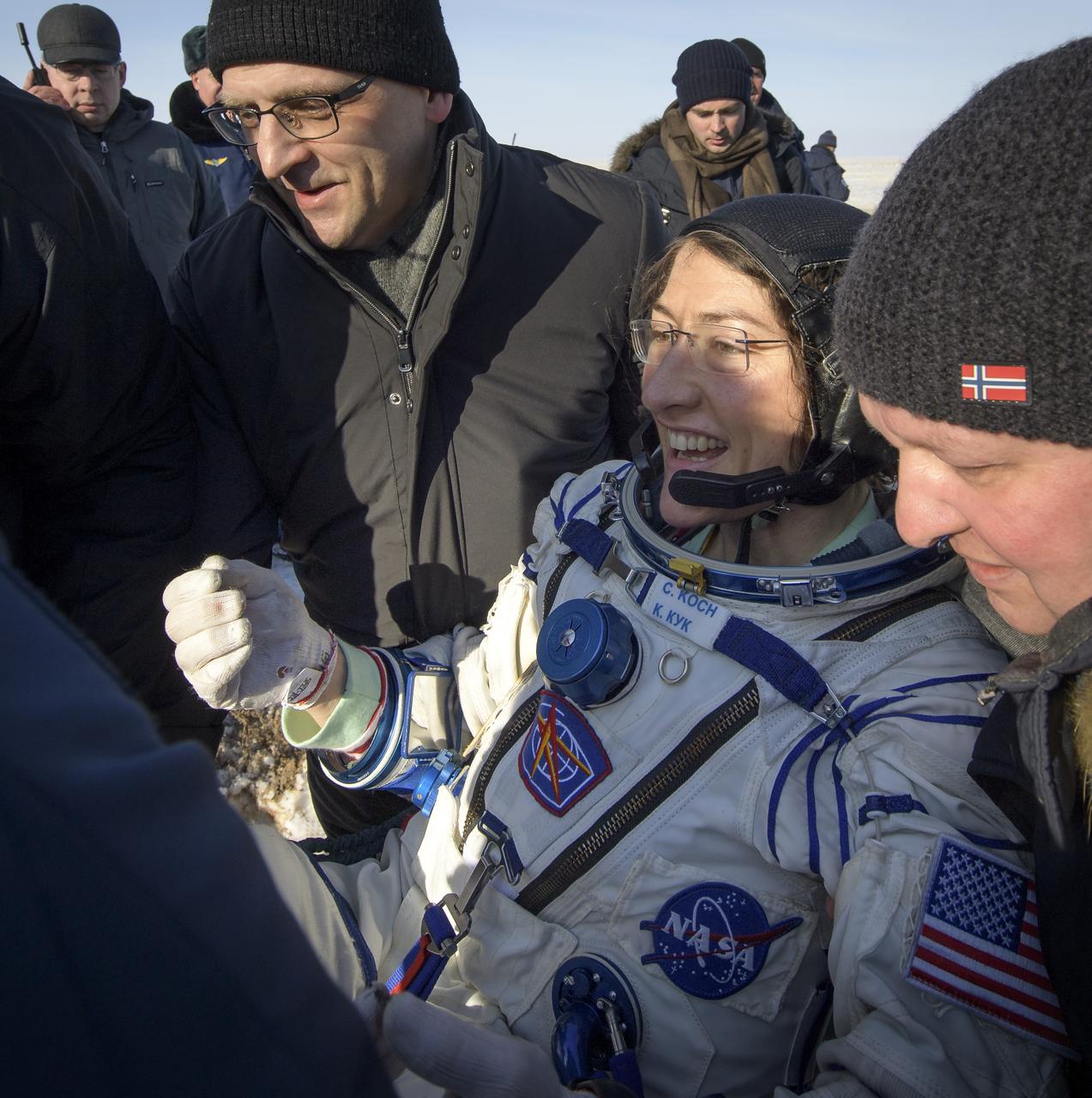 NASA astronaut Christina Koch is helped out of the Soyuz MS-13 spacecraft just minutes after she, Roscosmos cosmonaut Alexander Skvortsov, and ESA astronaut Luca Parmitano, landed in a remote area near the town of Zhezkazgan, Kazakhstan on Thursday, Feb. 6, 2020. Koch returned to Earth after logging 328 days in space --- the longest spaceflight in history by a woman --- as a member of Expeditions 59-60-61 on the International Space Station. Skvortsov and Parmitano returned after 201 days in space where they served as Expedition 60-61 crew members onboard the station. Photo Credit: (NASA/Bill Ingalls)