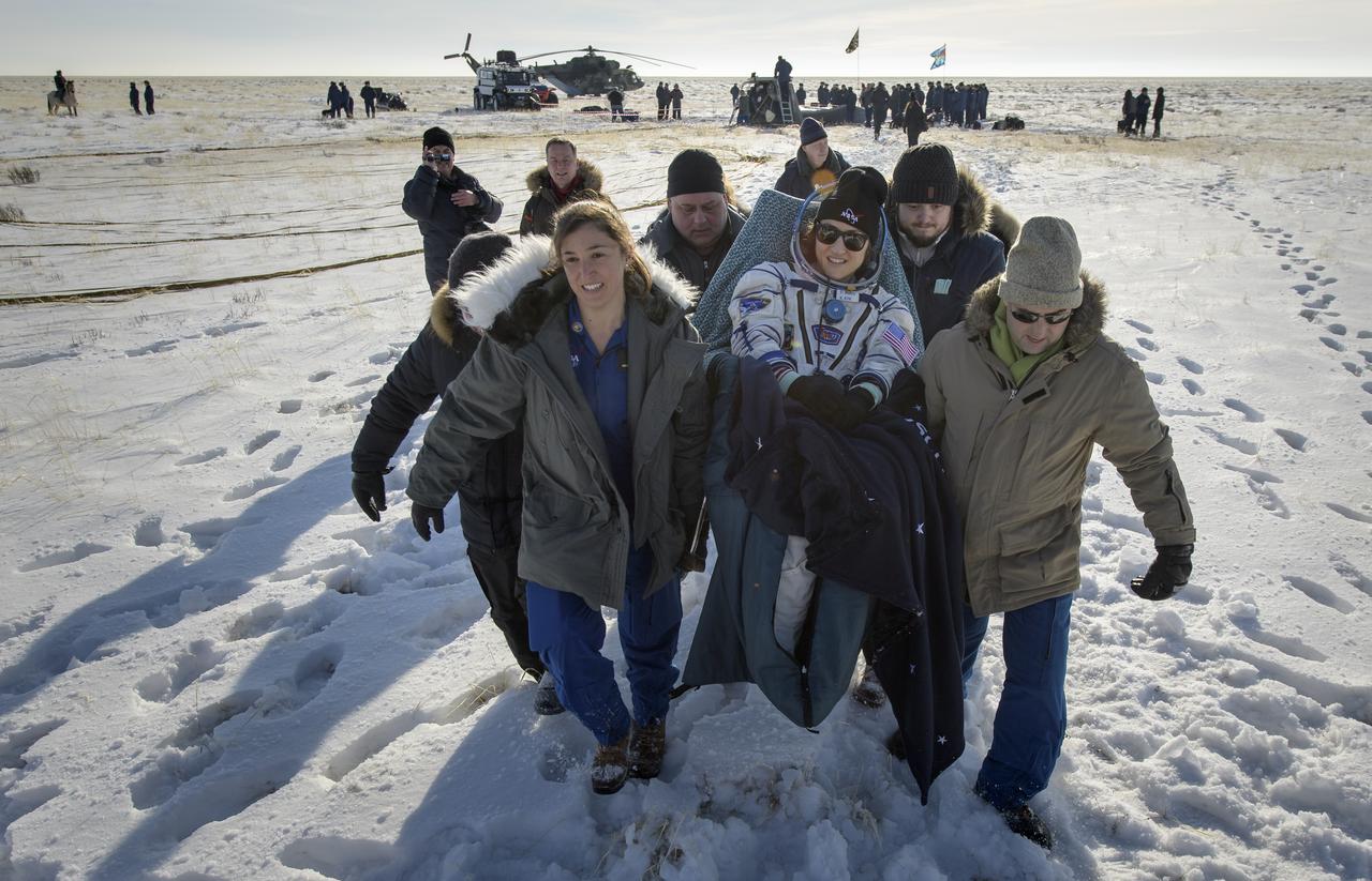 NASA astronaut Christina Koch is carried to a medical tent shortly after she, ESA astronaut Luca Parmitano, and Roscosmos cosmonaut Alexander Skvortsov landed in their Soyuz MS-13 spacecraft near the town of Zhezkazgan, Kazakhstan on Thursday, Feb. 6, 2020. Koch returned to Earth after logging 328 days in space --- the longest spaceflight in history by a woman --- as a member of Expeditions 59-60-61 on the International Space Station. Skvortsov and Parmitano returned after 201 days in space where they served as Expedition 60-61 crew members onboard the station. Photo Credit: (NASA/Bill Ingalls)