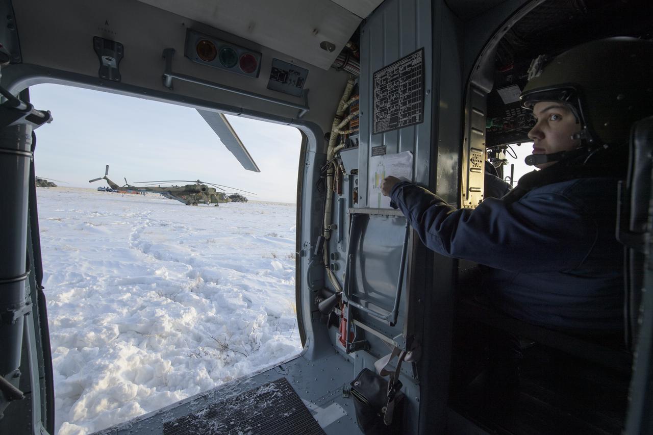A Russian helicopter crew members prepares to depart the Soyuz MS-13 spacecraft landing site with NASA astronaut Christina Koch after she, ESA astronaut Luca Parmitano, and Roscosmos cosmonaut Alexander Skvortsovis landed in a remote area near the town of Zhezkazgan, Kazakhstan Thursday, Feb. 6, 2020. Koch returned to Earth after logging 328 days in space --- the longest spaceflight in history by a woman --- as a member of Expeditions 59-60-61 on the International Space Station. Skvortsov and Parmitano returned after 201 days in space where they served as Expedition 60-61 crew members onboard the station. Photo Credit: (NASA/Bill Ingalls)