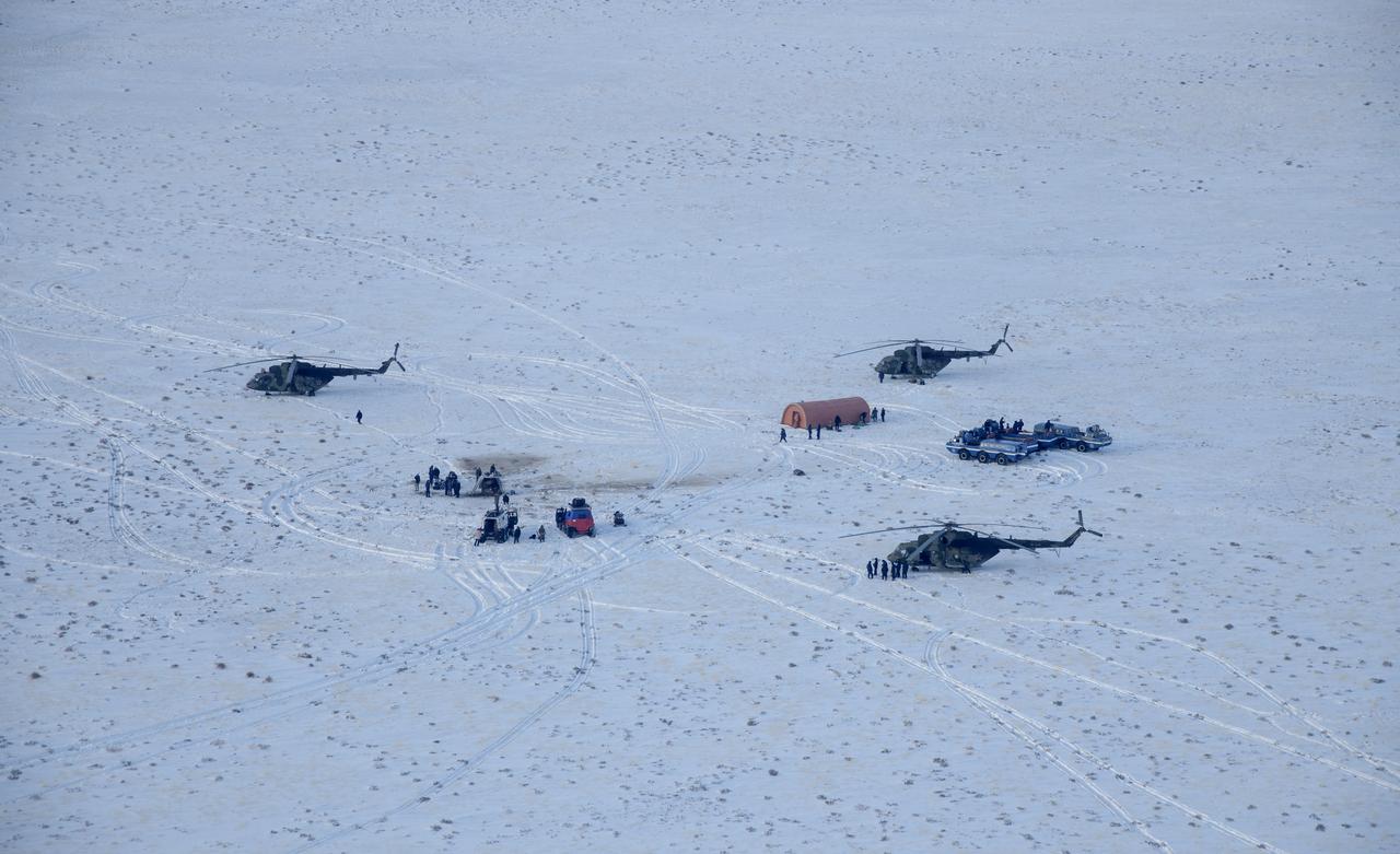 Russian support personnel work around the Soyuz MS-13 spacecraft after it landed in a remote area near the town of Zhezkazgan, Kazakhstan with Expedition 61 crew members Christina Koch of NASA, Alexander Skvortsov of the Russian space agency Roscosmos, and Luca Parmitano of ESA (European Space Agency) Thursday, Feb. 6, 2020. Koch returned to Earth after logging 328 days in space --- the longest spaceflight in history by a woman --- as a member of Expeditions 59-60-61 on the International Space Station. Skvortsov and Parmitano returned after 201 days in space where they served as Expedition 60-61 crew members onboard the station. Photo Credit: (NASA/Bill Ingalls)