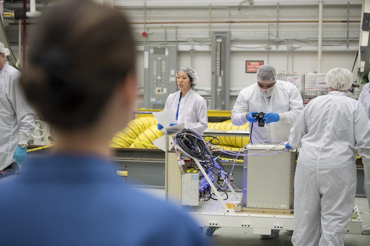 Mission engineers receive and prepare science and research and food items for the final cargo load into the Cygnus resupply spacecraft onboard the Northrop Grumman Antares rocket, Saturday, Feb. 8, 2020  at the Horizontal Integration Facility (HIF) of NASA's Wallops Flight Facility in Virginia. Northrop Grumman’s 13th contracted cargo resupply mission with NASA to the International Space Station will deliver more than 7,500 pounds of science and research, crew supplies and vehicle hardware to the orbital laboratory and its crew. Photo Credit: (NASA/Aubrey Gemignani)