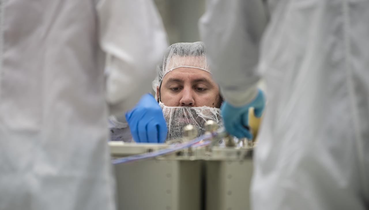 Mission engineers receive and prepare science and research and food items for the final cargo load into the Cygnus resupply spacecraft onboard the Northrop Grumman Antares rocket, Saturday, Feb. 8, 2020  at the Horizontal Integration Facility (HIF) of NASA's Wallops Flight Facility in Virginia. Northrop Grumman’s 13th contracted cargo resupply mission with NASA to the International Space Station will deliver more than 7,500 pounds of science and research, crew supplies and vehicle hardware to the orbital laboratory and its crew. Photo Credit: (NASA/Aubrey Gemignani)
