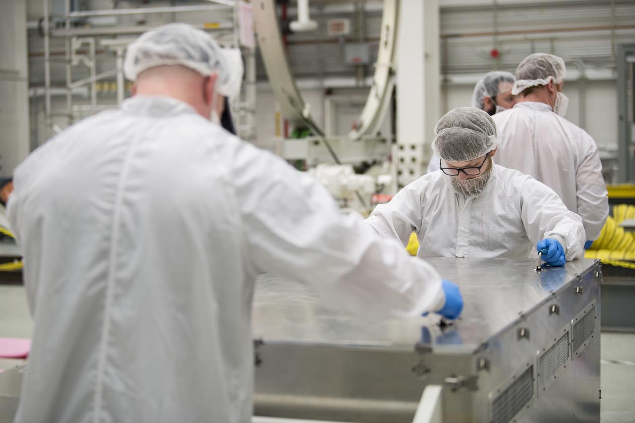 Mission engineers receive and prepare science and research and food items for the final cargo load into the Cygnus resupply spacecraft onboard the Northrop Grumman Antares rocket, Saturday, Feb. 8, 2020  at the Horizontal Integration Facility (HIF) of NASA's Wallops Flight Facility in Virginia. Northrop Grumman’s 13th contracted cargo resupply mission with NASA to the International Space Station will deliver more than 7,500 pounds of science and research, crew supplies and vehicle hardware to the orbital laboratory and its crew. Photo Credit: (NASA/Aubrey Gemignani)