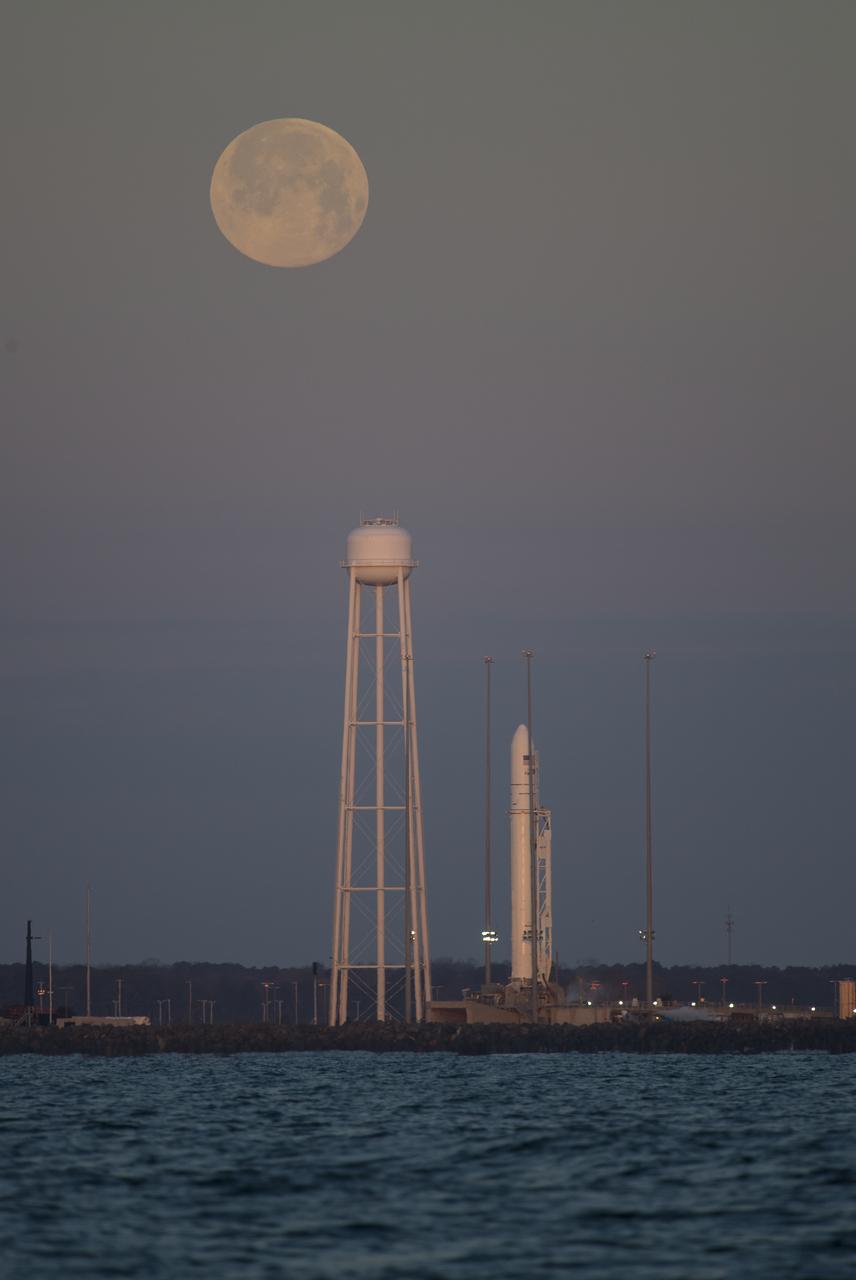 A Northrop Grumman Antares rocket carrying a Cygnus resupply spacecraft is seen at sunrise as the Moon sets on Pad-0A, Sunday, Feb. 9, 2020, at NASA's Wallops Flight Facility in Virginia. Northrop Grumman’s 13th contracted cargo resupply mission with NASA to the International Space Station will deliver more than 7,500 pounds of science and research, crew supplies and vehicle hardware to the orbital laboratory and its crew. The CRS-13 Cygnus spacecraft is named after the first African American astronaut, Major Robert Henry Lawrence Jr.. Photo Credit: (NASA/Aubrey Gemignani)
