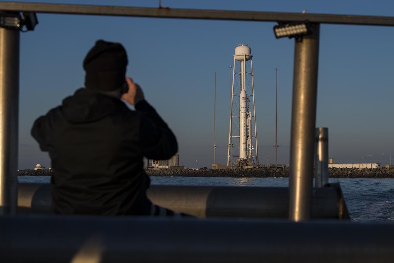 A Northrop Grumman Antares rocket carrying a Cygnus resupply spacecraft is seen out of the back of a boat at sunrise on Pad-0A, Sunday, Feb. 9, 2020, at NASA's Wallops Flight Facility in Virginia. Northrop Grumman’s 13th contracted cargo resupply mission with NASA to the International Space Station will deliver more than 7,500 pounds of science and research, crew supplies and vehicle hardware to the orbital laboratory and its crew. The CRS-13 Cygnus spacecraft is named after the first African American astronaut, Major Robert Henry Lawrence Jr.. Photo Credit: (NASA/Aubrey Gemignani)