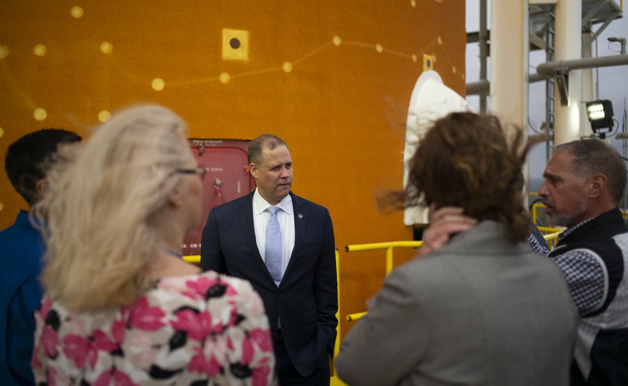 NASA Administrator Jim Bridenstine, center, is seen next to the first core stage of the agency’s Space Launch System (SLS) rocket along with Lisa Bates, SLS Deputy Stages Manager at NASA, Mark Nappi, Boeing Green Run Test Manager, Richard Gilbrech, Director of NASA's Stennis Space Center, Julie Bassler, SLS Stages Manager at NASA, and NASA astronaut Raja Chari, during a tour of the B-2 Test Stand, Monday, Feb. 10, 2020, at NASA’s Stennis Space Center near Bay St. Louis, Mississippi. Over the coming months, the first core stage of NASA’s SLS rocket will be undergoing a series of integrated Green Run tests prior to its maiden flight. Photo Credit: (NASA/Joel Kowsky)