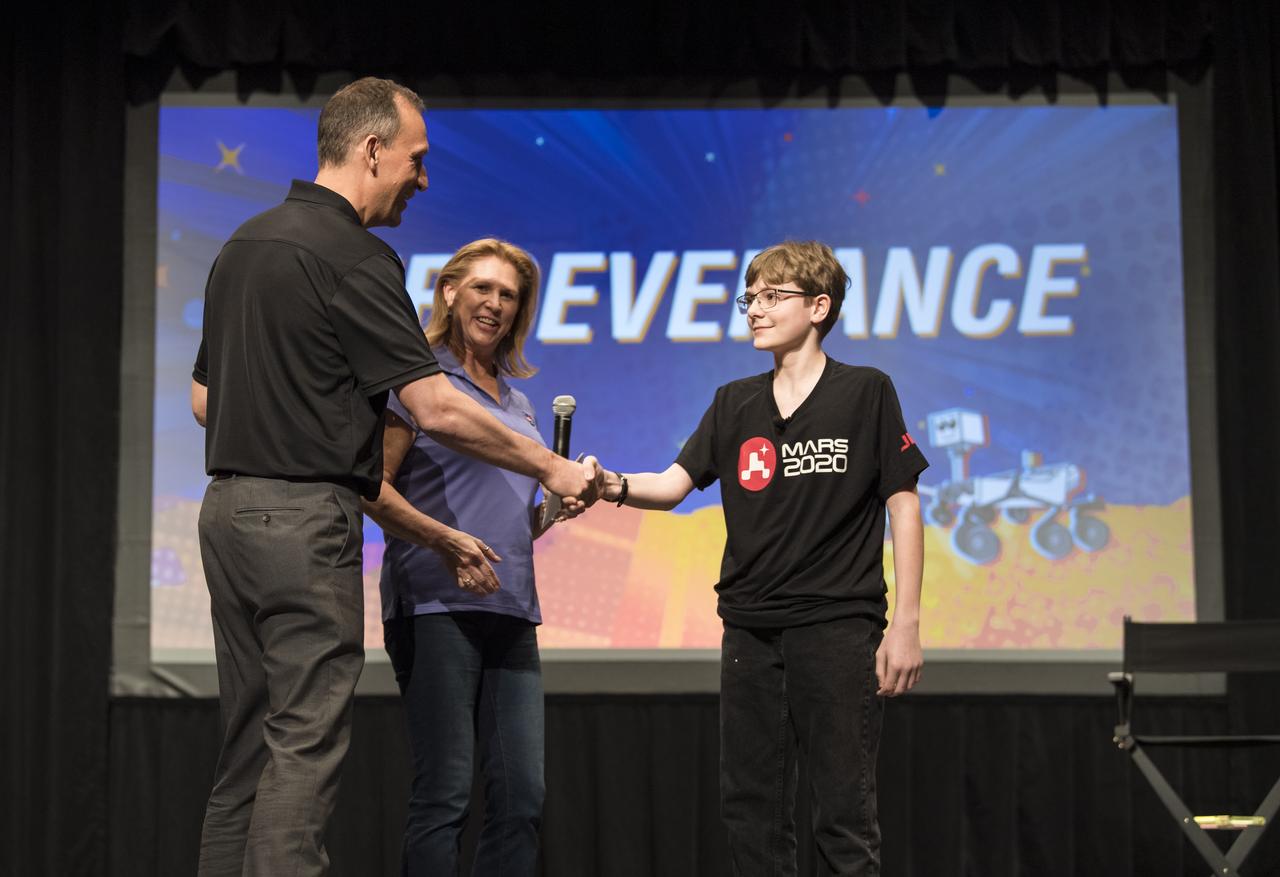 Associate Administrator of NASA's Science Mission Directorate, Thomas Zurbuchen, shakes hands with Alex Mather, the student whose submission, Perseverance, was chosen as the official name of the Mars 2020 rover, Thursday, March 5, 2020, at Lake Braddock Secondary School in Burke, Va. The final selection of the new name was made by Zurbuchen following a nationwide naming contest conducted in 2019 that drew more than 28,000 essays by K-12 students from every U.S. state and territory. Perseverance is currently at NASA's Kennedy Space Center in Florida being prepared for launch this summer. Photo Credit: (NASA/Aubrey Gemignani)