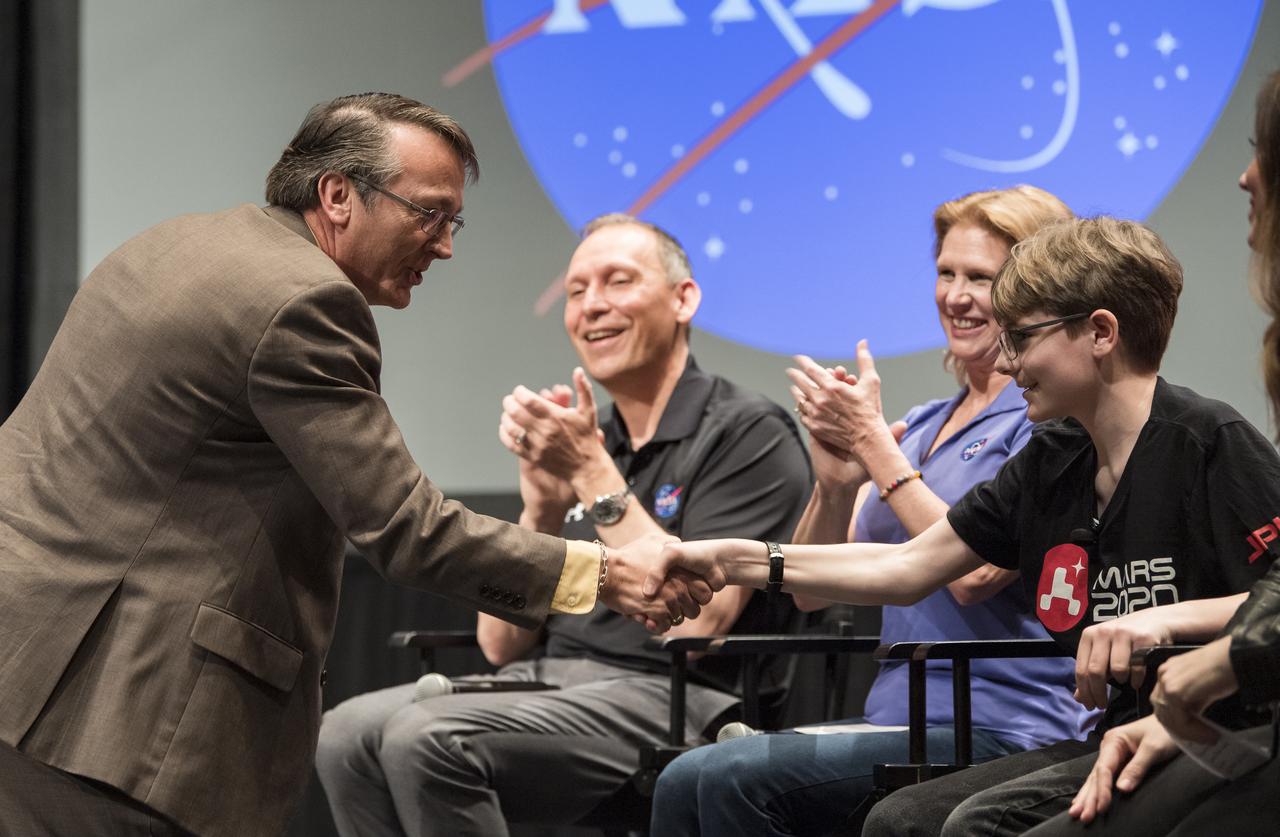 Fairfax County Division Superintendent Scott Brabrand shakes hands with Alex Mather, the student whose submission, Perseverance, was chosen as the official name of the Mars 2020 rover, Thursday, March 5, 2020, at Lake Braddock Secondary School in Burke, Va. The final selection of the new name was made by Zurbuchen following a nationwide naming contest conducted in 2019 that drew more than 28,000 essays by K-12 students from every U.S. state and territory. Perseverance is currently at NASA's Kennedy Space Center in Florida being prepared for launch this summer. Photo Credit: (NASA/Aubrey Gemignani)