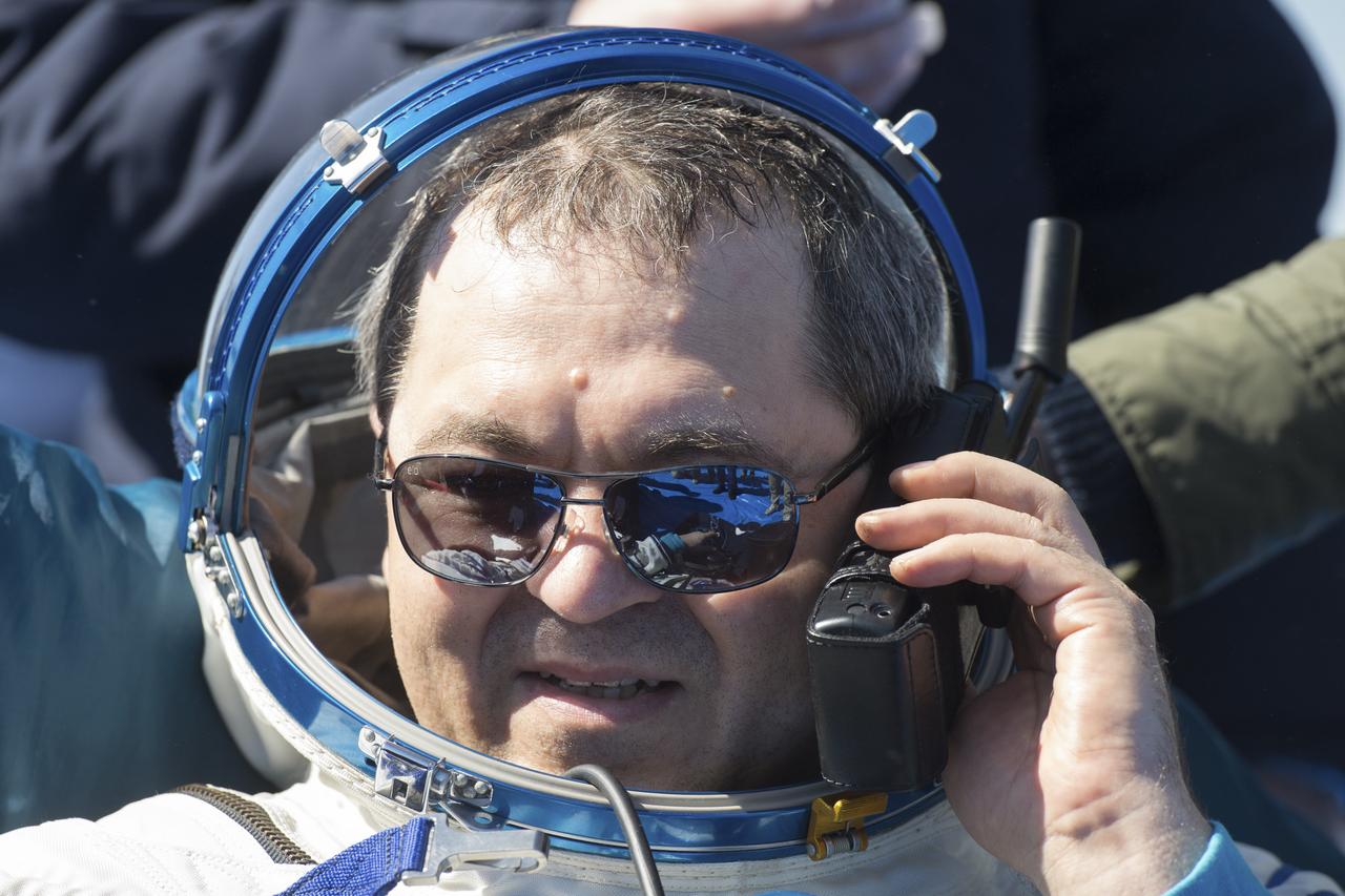 Expedition 62 cosmonaut Oleg Skripochka is seen talking to family via satellite phone outside the Soyuz MS-15 spacecraft after he landed with NASA astronauts Andrew Morgan and Jessica Meir in a remote area near the town of Zhezkazgan, Kazakhstan on Friday, April 17, 2020. Meir and Skripochka returned after 205 days in space, and Morgan after 272 days in space. All three served as Expedition 60-61-62 crew members onboard the International Space Station. Photo Credit: (NASA/GCTC/Andrey Shelepin)
