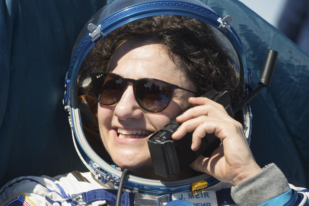 Expedition 62 astronaut Jessica Meir is seen talking on the satellite phone outside the Soyuz MS-15 spacecraft after she landed with NASA astronaut Andrew Morgan and Roscosmos cosmonaut Oleg Skripochka in a remote area near the town of Zhezkazgan, Kazakhstan on Friday, April 17, 2020. Meir and Skripochka returned after 205 days in space, and Morgan after 272 days in space. All three served as Expedition 60-61-62 crew members onboard the International Space Station. Photo Credit: (NASA/GCTC/Andrey Shelepin)