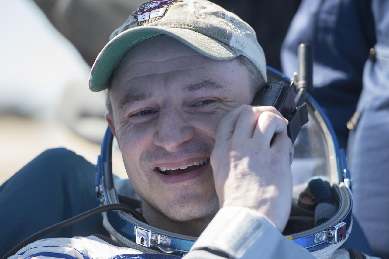 Expedition 62 astronaut Andrew Morgan is seen talking on the satellite phone outside the Soyuz MS-15 spacecraft after he landed with NASA astronaut Jessica Meir and Roscosmos cosmonaut Oleg Skripochka in a remote area near the town of Zhezkazgan, Kazakhstan on Friday, April 17, 2020. Meir and Skripochka returned after 205 days in space, and Morgan after 272 days in space. All three served as Expedition 60-61-62 crew members onboard the International Space Station. Photo Credit: (NASA/GCTC/Andrey Shelepin)