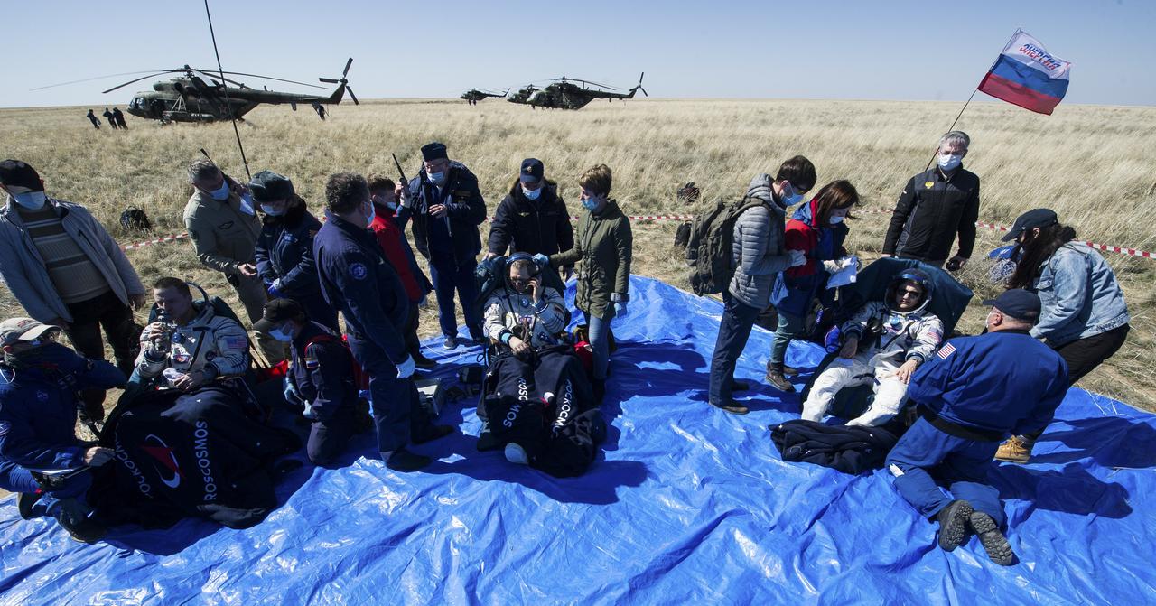 Expedition 62 crew members Andrew Morgan of NASA, left, Oleg Skripochka of Roscosmos, center, and Jessica Meir of NASA sit in chairs outside the Soyuz MS-15 spacecraft after they landed in a remote area near the town of Zhezkazgan, Kazakhstan on Friday, April 17, 2020. Meir and Skripochka returned after 205 days in space, and Morgan after 272 days in space. All three served as Expedition 60-61-62 crew members onboard the International Space Station. Photo Credit: (NASA/GCTC/Andrey Shelepin)