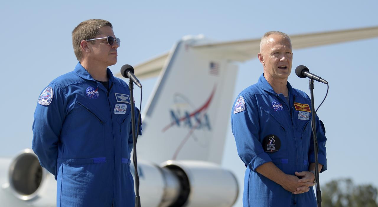 NASA astronauts Robert Behnken, left, and Douglas Hurley speak to members of the media after arriving at the Launch and Landing Facility at NASA’s Kennedy Space Center ahead of SpaceX’s Demo-2 mission, Wednesday, May 20, 2020, in Florida. NASA’s SpaceX Demo-2 mission is the first launch with astronauts of the SpaceX Crew Dragon spacecraft and Falcon 9 rocket to the International Space Station as part of the agency’s Commercial Crew Program. The flight test will serve as an end-to-end demonstration of SpaceX’s crew transportation system. Behnken and Hurley are scheduled to launch at 4:33 p.m. EDT on Wednesday, May 27, from Launch Complex 39A at the Kennedy Space Center. A new era of human spaceflight is set to begin as American astronauts once again launch on an American rocket from American soil to low-Earth orbit for the first time since the conclusion of the Space Shuttle Program in 2011.  Photo Credit: (NASA/Bill Ingalls)