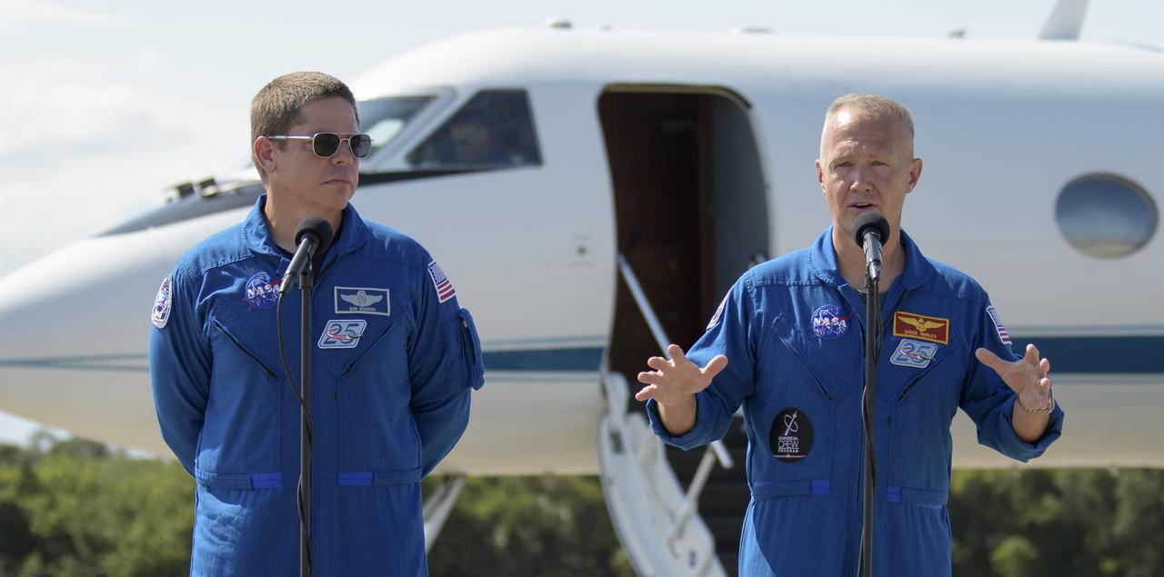 NASA astronauts Robert Behnken, left, and Douglas Hurley speak to members of the media after arriving at the Launch and Landing Facility at NASA’s Kennedy Space Center ahead of SpaceX’s Demo-2 mission, Wednesday, May 20, 2020, in Florida. NASA’s SpaceX Demo-2 mission is the first launch with astronauts of the SpaceX Crew Dragon spacecraft and Falcon 9 rocket to the International Space Station as part of the agency’s Commercial Crew Program. The flight test will serve as an end-to-end demonstration of SpaceX’s crew transportation system. Behnken and Hurley are scheduled to launch at 4:33 p.m. EDT on Wednesday, May 27, from Launch Complex 39A at the Kennedy Space Center. A new era of human spaceflight is set to begin as American astronauts once again launch on an American rocket from American soil to low-Earth orbit for the first time since the conclusion of the Space Shuttle Program in 2011.  Photo Credit: (NASA/Bill Ingalls)
