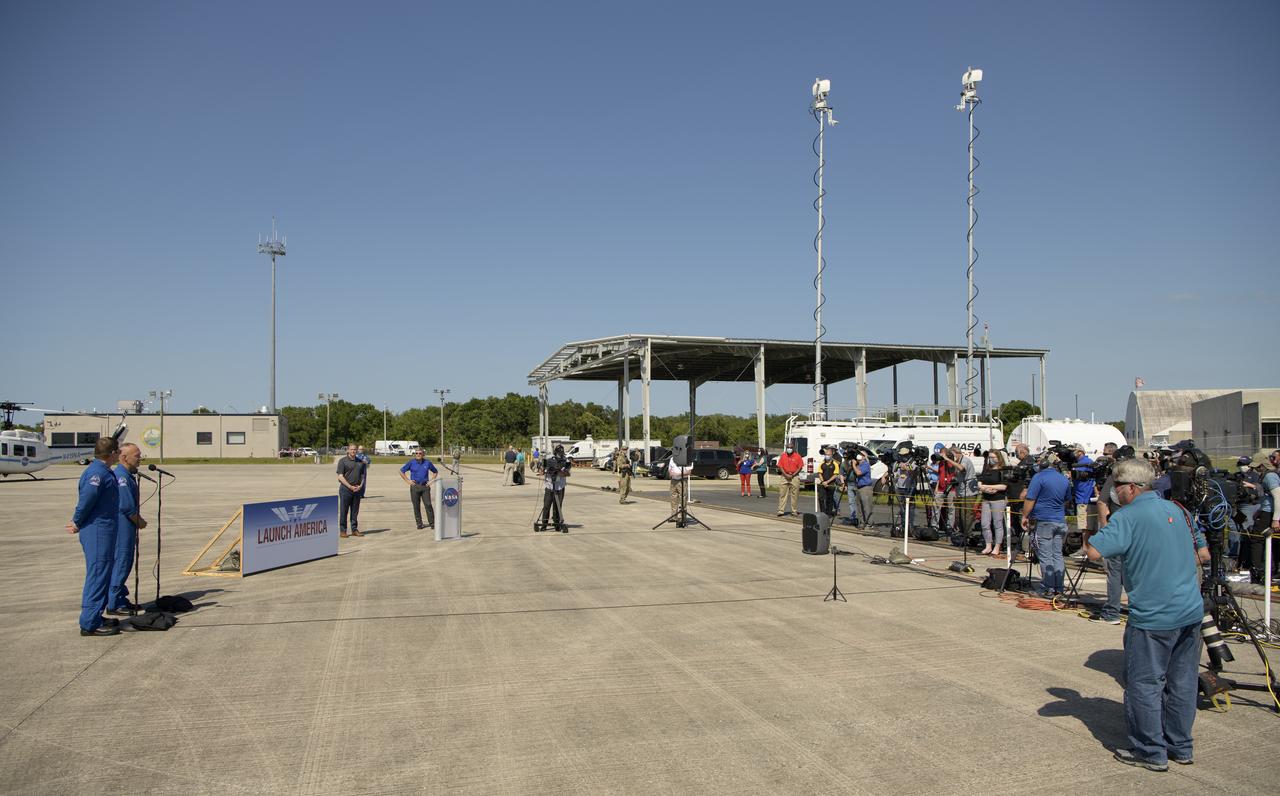 NASA astronauts Robert Behnken, left, and Douglas Hurley speak to members of the media after arriving at the Launch and Landing Facility at NASA’s Kennedy Space Center ahead of SpaceX’s Demo-2 mission, Wednesday, May 20, 2020, in Florida. NASA’s SpaceX Demo-2 mission is the first launch with astronauts of the SpaceX Crew Dragon spacecraft and Falcon 9 rocket to the International Space Station as part of the agency’s Commercial Crew Program. The flight test will serve as an end-to-end demonstration of SpaceX’s crew transportation system. Behnken and Hurley are scheduled to launch at 4:33 p.m. EDT on Wednesday, May 27, from Launch Complex 39A at the Kennedy Space Center. A new era of human spaceflight is set to begin as American astronauts once again launch on an American rocket from American soil to low-Earth orbit for the first time since the conclusion of the Space Shuttle Program in 2011.  Photo Credit: (NASA/Bill Ingalls)