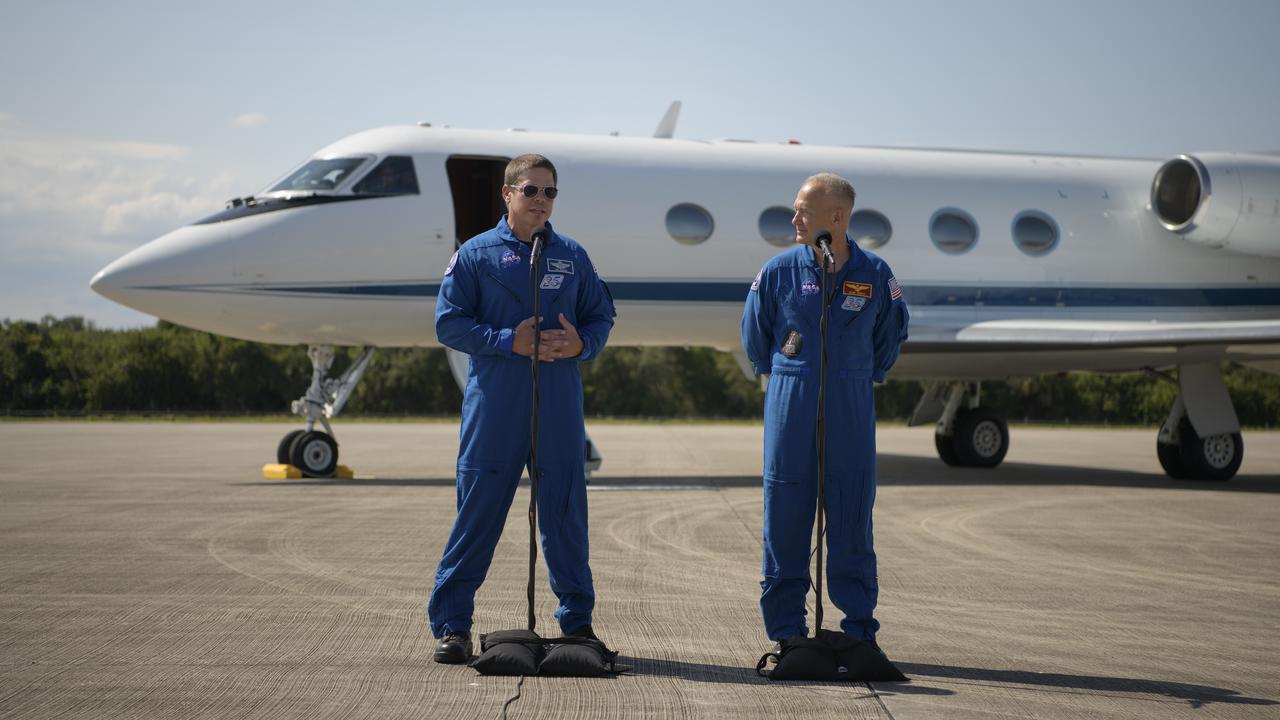 NASA astronauts Robert Behnken, left, and Douglas Hurley speak to members of the media after arriving at the Launch and Landing Facility at NASA’s Kennedy Space Center ahead of SpaceX’s Demo-2 mission, Wednesday, May 20, 2020, in Florida. NASA’s SpaceX Demo-2 mission is the first launch with astronauts of the SpaceX Crew Dragon spacecraft and Falcon 9 rocket to the International Space Station as part of the agency’s Commercial Crew Program. The flight test will serve as an end-to-end demonstration of SpaceX’s crew transportation system. Behnken and Hurley are scheduled to launch at 4:33 p.m. EDT on Wednesday, May 27, from Launch Complex 39A at the Kennedy Space Center. A new era of human spaceflight is set to begin as American astronauts once again launch on an American rocket from American soil to low-Earth orbit for the first time since the conclusion of the Space Shuttle Program in 2011.  Photo Credit: (NASA/Bill Ingalls)