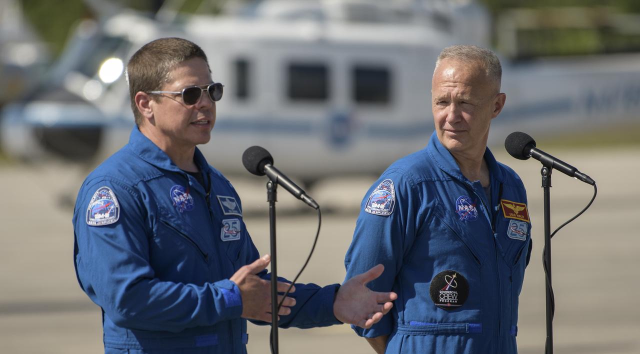 NASA astronauts Robert Behnken, left, and Douglas Hurley speak to members of the media after arriving at the Launch and Landing Facility at NASA’s Kennedy Space Center ahead of SpaceX’s Demo-2 mission, Wednesday, May 20, 2020, in Florida. NASA’s SpaceX Demo-2 mission is the first launch with astronauts of the SpaceX Crew Dragon spacecraft and Falcon 9 rocket to the International Space Station as part of the agency’s Commercial Crew Program. The flight test will serve as an end-to-end demonstration of SpaceX’s crew transportation system. Behnken and Hurley are scheduled to launch at 4:33 p.m. EDT on Wednesday, May 27, from Launch Complex 39A at the Kennedy Space Center. A new era of human spaceflight is set to begin as American astronauts once again launch on an American rocket from American soil to low-Earth orbit for the first time since the conclusion of the Space Shuttle Program in 2011.  Photo Credit: (NASA/Bill Ingalls)