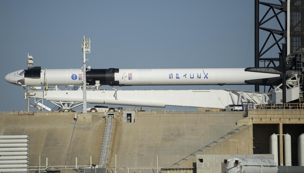 A SpaceX Falcon 9 rocket with the company's Crew Dragon spacecraft onboard is seen prior to being raised into a vertical position on the launch pad at Launch Complex 39A as preparations continue for the Demo-2 mission, Thursday, May 21, 2020, at NASA’s Kennedy Space Center in Florida. NASA’s SpaceX Demo-2 mission is the first launch with astronauts of the SpaceX Crew Dragon spacecraft and Falcon 9 rocket to the International Space Station as part of the agency’s Commercial Crew Program. The flight test will serve as an end-to-end demonstration of SpaceX’s crew transportation system. Behnken and Hurley are scheduled to launch at 4:33 p.m. EDT on Wednesday, May 27, from Launch Complex 39A at the Kennedy Space Center. A new era of human spaceflight is set to begin as American astronauts once again launch on an American rocket from American soil to low-Earth orbit for the first time since the conclusion of the Space Shuttle Program in 2011. Photo Credit: (NASA/Bill Ingalls)