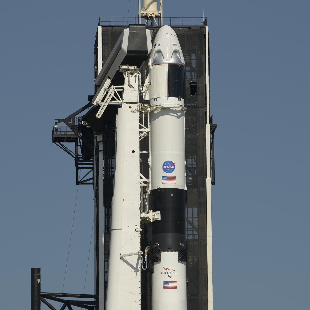 A SpaceX Falcon 9 rocket with the company's Crew Dragon spacecraft onboard is seen as it is raised into a vertical position on the launch pad at Launch Complex 39A as preparations continue for the Demo-2 mission, Thursday, May 21, 2020, at NASA’s Kennedy Space Center in Florida. NASA’s SpaceX Demo-2 mission is the first launch with astronauts of the SpaceX Crew Dragon spacecraft and Falcon 9 rocket to the International Space Station as part of the agency’s Commercial Crew Program. The flight test will serve as an end-to-end demonstration of SpaceX’s crew transportation system. Behnken and Hurley are scheduled to launch at 4:33 p.m. EDT on Wednesday, May 27, from Launch Complex 39A at the Kennedy Space Center. A new era of human spaceflight is set to begin as American astronauts once again launch on an American rocket from American soil to low-Earth orbit for the first time since the conclusion of the Space Shuttle Program in 2011. Photo Credit: (NASA/Bill Ingalls)