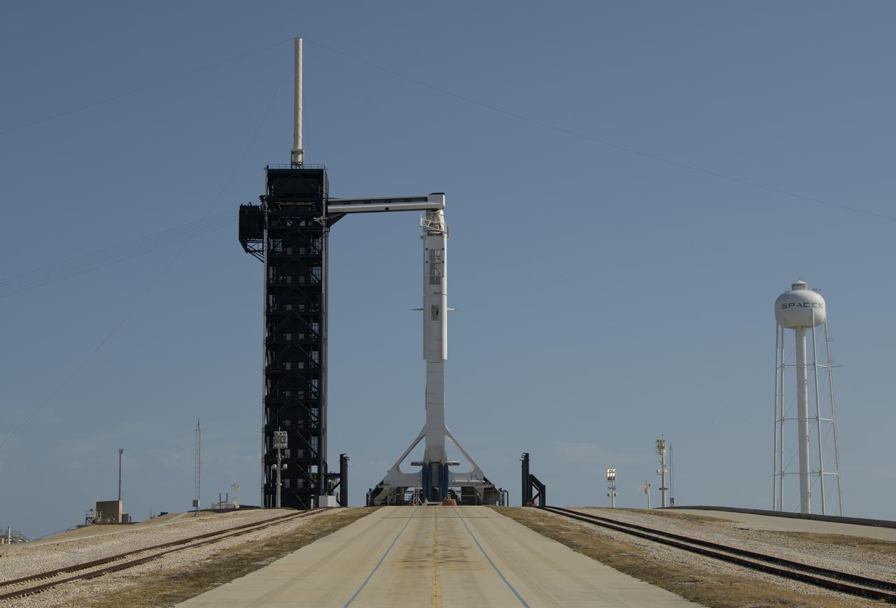 A SpaceX Falcon 9 rocket with the company's Crew Dragon spacecraft onboard is seen as it is raised into a vertical position on the launch pad at Launch Complex 39A as preparations continue for the Demo-2 mission, Thursday, May 21, 2020, at NASA’s Kennedy Space Center in Florida. NASA’s SpaceX Demo-2 mission is the first launch with astronauts of the SpaceX Crew Dragon spacecraft and Falcon 9 rocket to the International Space Station as part of the agency’s Commercial Crew Program. The flight test will serve as an end-to-end demonstration of SpaceX’s crew transportation system. Behnken and Hurley are scheduled to launch at 4:33 p.m. EDT on Wednesday, May 27, from Launch Complex 39A at the Kennedy Space Center. A new era of human spaceflight is set to begin as American astronauts once again launch on an American rocket from American soil to low-Earth orbit for the first time since the conclusion of the Space Shuttle Program in 2011. Photo Credit: (NASA/Bill Ingalls)