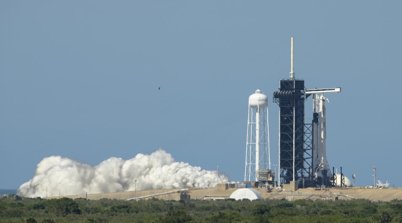 A SpaceX Falcon 9 rocket with the company's Crew Dragon spacecraft onboard is seen on the launch pad at Launch Complex 39A during a brief static fire test ahead of NASA’s SpaceX Demo-2 mission, Friday, May 22, 2020, at NASA’s Kennedy Space Center in Florida. NASA’s SpaceX Demo-2 mission is the first launch with astronauts of the SpaceX Crew Dragon spacecraft and Falcon 9 rocket to the International Space Station as part of the agency’s Commercial Crew Program. The test flight serves as an end-to-end demonstration of SpaceX’s crew transportation system. Robert Behnken and Douglas Hurley are scheduled to launch at 4:33 p.m. EDT on Wednesday, May 27, from Launch Complex 39A at the Kennedy Space Center. A new era of human spaceflight is set to begin as American astronauts once again launch on an American rocket from American soil to low-Earth orbit for the first time since the conclusion of the Space Shuttle Program in 2011. Photo Credit: (NASA/Bill Ingalls)