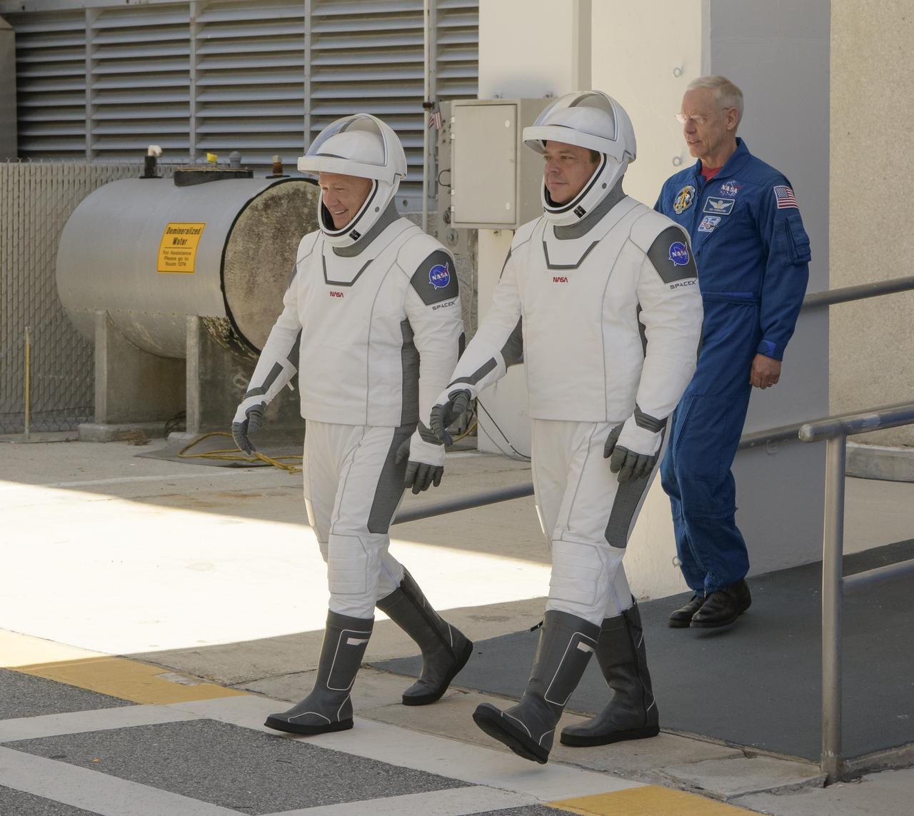 NASA astronauts Douglas Hurley, left, and Robert Behnken, wearing SpaceX spacesuits, are seen as they depart the Neil A. Armstrong Operations and Checkout Building for Launch Complex 39A during a dress rehearsal prior to the Demo-2 mission launch, Saturday, May 23, 2020, at NASA’s Kennedy Space Center in Florida. NASA’s SpaceX Demo-2 mission is the first launch with astronauts of the SpaceX Crew Dragon spacecraft and Falcon 9 rocket to the International Space Station as part of the agency’s Commercial Crew Program. The test flight serves as an end-to-end demonstration of SpaceX’s crew transportation system. Behnken and Hurley are scheduled to launch at 4:33 p.m. EDT on Wednesday, May 27, from Launch Complex 39A at the Kennedy Space Center. A new era of human spaceflight is set to begin as American astronauts once again launch on an American rocket from American soil to low-Earth orbit for the first time since the conclusion of the Space Shuttle Program in 2011.  Photo Credit: (NASA/Bill Ingalls)