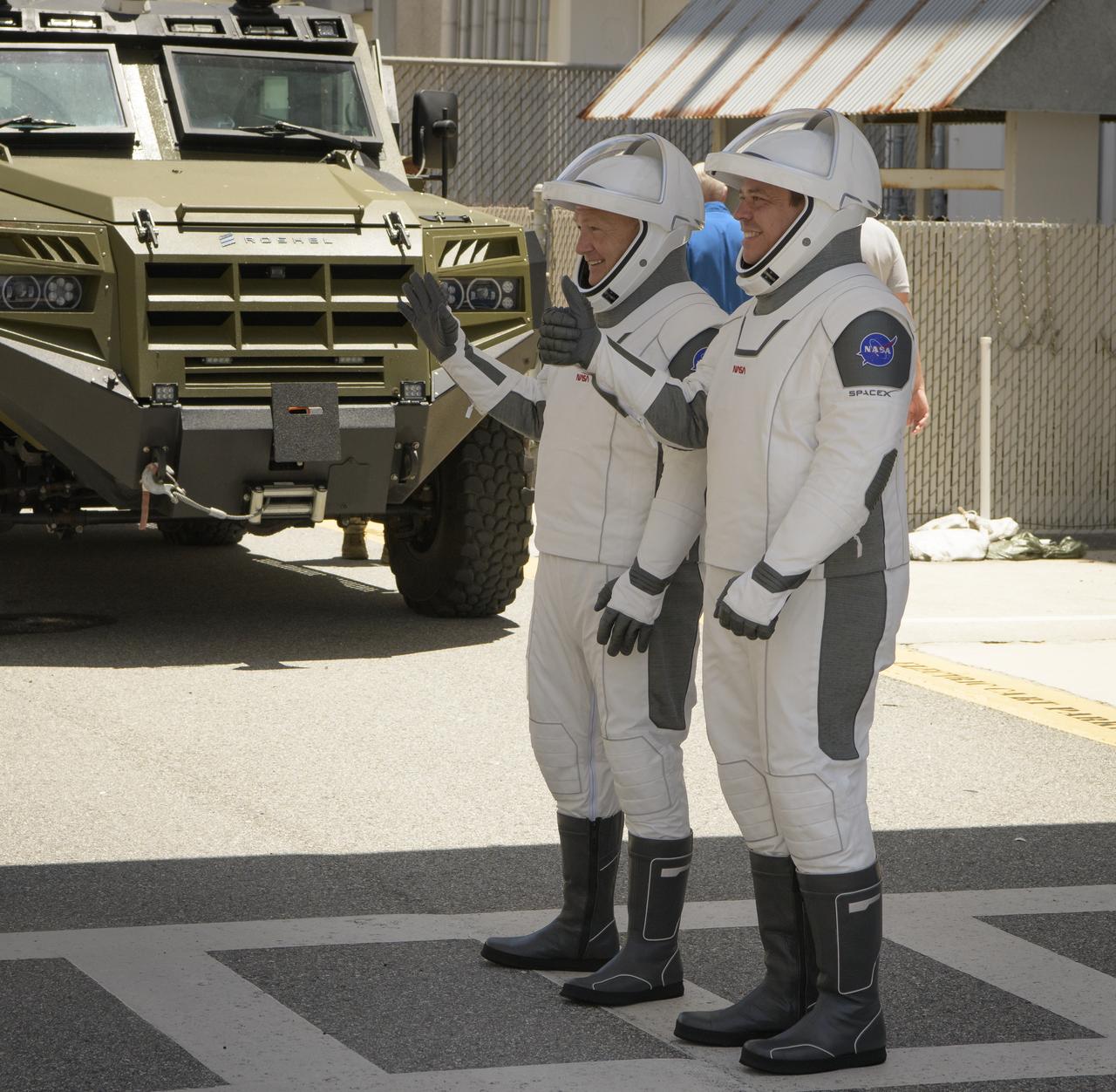 NASA astronauts Douglas Hurley, left, and Robert Behnken, wearing SpaceX spacesuits, are seen as they depart the Neil A. Armstrong Operations and Checkout Building for Launch Complex 39A during a dress rehearsal prior to the Demo-2 mission launch, Saturday, May 23, 2020, at NASA’s Kennedy Space Center in Florida. NASA’s SpaceX Demo-2 mission is the first launch with astronauts of the SpaceX Crew Dragon spacecraft and Falcon 9 rocket to the International Space Station as part of the agency’s Commercial Crew Program. The test flight serves as an end-to-end demonstration of SpaceX’s crew transportation system. Behnken and Hurley are scheduled to launch at 4:33 p.m. EDT on Wednesday, May 27, from Launch Complex 39A at the Kennedy Space Center. A new era of human spaceflight is set to begin as American astronauts once again launch on an American rocket from American soil to low-Earth orbit for the first time since the conclusion of the Space Shuttle Program in 2011.  Photo Credit: (NASA/Bill Ingalls)