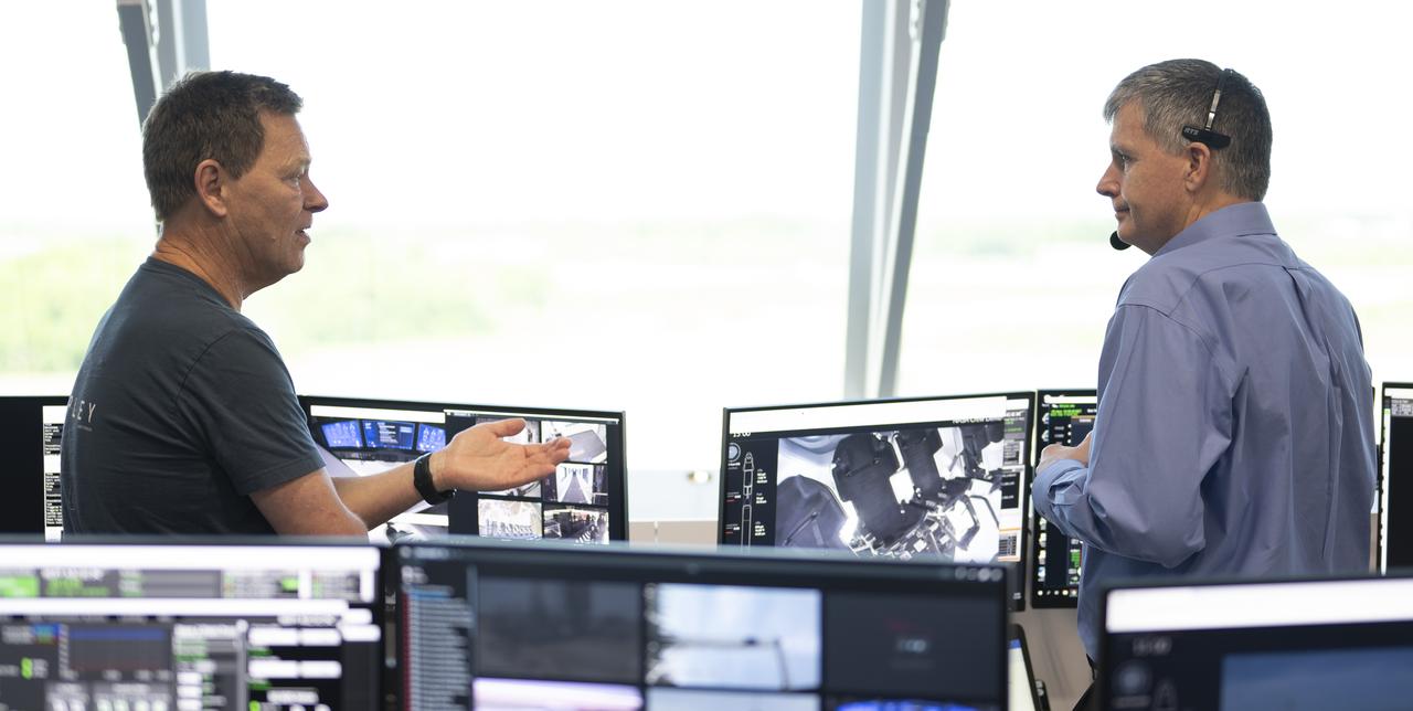 Hans Koenigsmann, vice president for build and flight reliability at SpaceX, left, and Steve Stich, deputy manager of NASA’s Commercial Crew Program, right, are seen as they monitor the countdown during a dress rehearsal in preparation for the launch of a SpaceX Falcon 9 rocket carrying the company's Crew Dragon spacecraft on NASA’s SpaceX Demo-2 mission with NASA astronauts Robert Behnken and Douglas Hurley onboard, Saturday, May 23, 2020, in firing room four of the Launch Control Center at NASA’s Kennedy Space Center in Florida. NASA’s SpaceX Demo-2 mission is the first launch with astronauts of the SpaceX Crew Dragon spacecraft and Falcon 9 rocket to the International Space Station as part of the agency’s Commercial Crew Program. The test flight serves as an end-to-end demonstration of SpaceX’s crew transportation system. Behnken and Hurley are scheduled to launch at 4:33 p.m. EDT on Wednesday, May 27, from Launch Complex 39A at the Kennedy Space Center. A new era of human spaceflight is set to begin as American astronauts once again launch on an American rocket from American soil to low-Earth orbit for the first time since the conclusion of the Space Shuttle Program in 2011. Photo Credit: (NASA/Joel Kowsky)