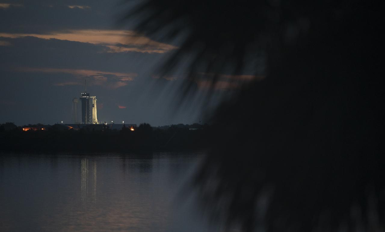 A SpaceX Falcon 9 rocket with the company's Crew Dragon spacecraft onboard is seen on the launch pad at Launch Complex 39A at sunrise as preparations continue for the Demo-2 mission, Wednesday, May 27, 2020, at NASA’s Kennedy Space Center in Florida. NASA’s SpaceX Demo-2 mission is the first launch with astronauts of the SpaceX Crew Dragon spacecraft and Falcon 9 rocket to the International Space Station as part of the agency’s Commercial Crew Program. The test flight serves as an end-to-end demonstration of SpaceX’s crew transportation system. Robert Behnken and Douglas Hurley are scheduled to launch at 4:33 p.m. EDT on Wednesday, May 27, from Launch Complex 39A at the Kennedy Space Center. A new era of human spaceflight is set to begin as American astronauts once again launch on an American rocket from American soil to low-Earth orbit for the first time since the conclusion of the Space Shuttle Program in 2011. Photo Credit: (NASA/Joel Kowsky)