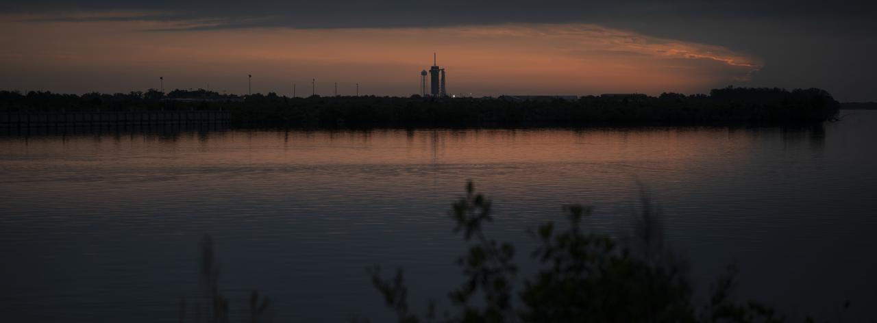 A SpaceX Falcon 9 rocket with the company's Crew Dragon spacecraft onboard is seen on the launch pad at Launch Complex 39A at sunrise as preparations continue for the Demo-2 mission, Wednesday, May 27, 2020, at NASA’s Kennedy Space Center in Florida. NASA’s SpaceX Demo-2 mission is the first launch with astronauts of the SpaceX Crew Dragon spacecraft and Falcon 9 rocket to the International Space Station as part of the agency’s Commercial Crew Program. The test flight serves as an end-to-end demonstration of SpaceX’s crew transportation system. Robert Behnken and Douglas Hurley are scheduled to launch at 4:33 p.m. EDT on Wednesday, May 27, from Launch Complex 39A at the Kennedy Space Center. A new era of human spaceflight is set to begin as American astronauts once again launch on an American rocket from American soil to low-Earth orbit for the first time since the conclusion of the Space Shuttle Program in 2011. Photo Credit: (NASA/Joel Kowsky)