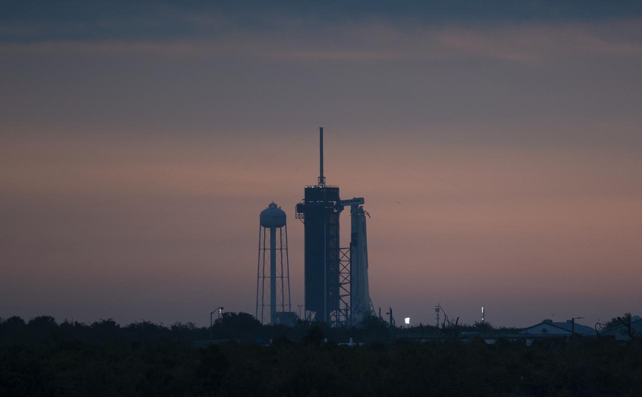 A SpaceX Falcon 9 rocket with the company's Crew Dragon spacecraft onboard is seen on the launch pad at Launch Complex 39A at sunrise as preparations continue for the Demo-2 mission, Wednesday, May 27, 2020, at NASA’s Kennedy Space Center in Florida. NASA’s SpaceX Demo-2 mission is the first launch with astronauts of the SpaceX Crew Dragon spacecraft and Falcon 9 rocket to the International Space Station as part of the agency’s Commercial Crew Program. The test flight serves as an end-to-end demonstration of SpaceX’s crew transportation system. Robert Behnken and Douglas Hurley are scheduled to launch at 4:33 p.m. EDT on Wednesday, May 27, from Launch Complex 39A at the Kennedy Space Center. A new era of human spaceflight is set to begin as American astronauts once again launch on an American rocket from American soil to low-Earth orbit for the first time since the conclusion of the Space Shuttle Program in 2011. Photo Credit: (NASA/Joel Kowsky)