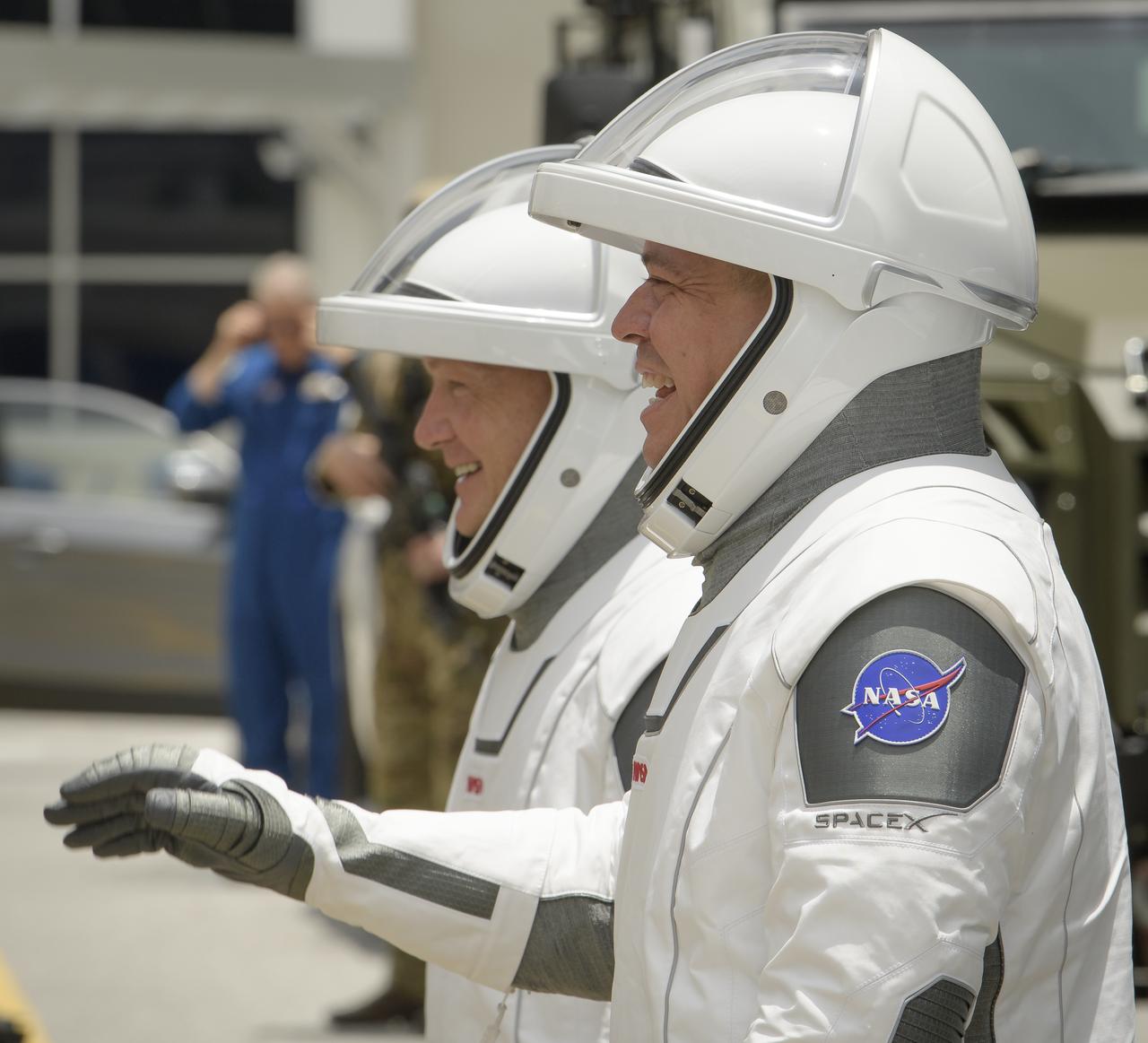 NASA astronauts Douglas Hurley, left, and Robert Behnken, wearing SpaceX spacesuits, are seen as they depart the Neil A. Armstrong Operations and Checkout Building for Launch Complex 39A to board the SpaceX Crew Dragon spacecraft for the Demo-2 mission launch, Wednesday, May 27, 2020, at NASA’s Kennedy Space Center in Florida. NASA’s SpaceX Demo-2 mission is the first launch with astronauts of the SpaceX Crew Dragon spacecraft and Falcon 9 rocket to the International Space Station as part of the agency’s Commercial Crew Program. The test flight serves as an end-to-end demonstration of SpaceX’s crew transportation system. Behnken and Hurley are scheduled to launch at 4:33 p.m. EDT on Wednesday, May 27, from Launch Complex 39A at the Kennedy Space Center. A new era of human spaceflight is set to begin as American astronauts once again launch on an American rocket from American soil to low-Earth orbit for the first time since the conclusion of the Space Shuttle Program in 2011. Photo Credit: (NASA/Bill Ingalls)