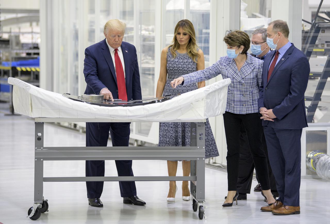 President Donald Trump, First Lady Melania Trump, Marillyn Hewson, Chief Executive Officer, Lockheed Martin, Mike Hawes, VP of Human Space Exploration and Orion Program Manager at Lockheed Martin Space, and NASA Administrator Jim Bridenstine, right, are seen looking at an Orion capsule hatch that will be used for the Artemis II mission during a tour of the Neil A. Armstrong Operations and Checkout Building following the departure of NASA astronauts Robert Behnken and Douglas Hurley for Launch Complex 39A to board a SpaceX Crew Dragon spacecraft for launch, Wednesday, May 27, 2020, at NASA’s Kennedy Space Center in Florida. NASA’s SpaceX Demo-2 mission is the first launch with astronauts of the SpaceX Crew Dragon spacecraft and Falcon 9 rocket to the International Space Station as part of the agency’s Commercial Crew Program. The flight test will serve as an end-to-end demonstration of SpaceX’s crew transportation system. Today’s launch of Behnken and Hurley was scrubbed due to weather and is now scheduled for 3:22 p.m. EDT on Saturday, May 30, from Launch Complex 39A at the Kennedy Space Center. A new era of human spaceflight is set to begin as American astronauts once again launch on an American rocket from American soil to low-Earth orbit for the first time since the conclusion of the Space Shuttle Program in 2011. Photo Credit: (NASA/Bill Ingalls)