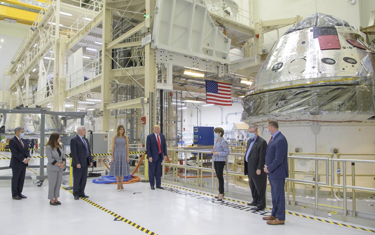 President Donald Trump, First Lady Melania Trump, Vice President Mike Pence, Second Lady Karen Pence, along with Kennedy Space Center Director Bob Cabana, left, Marillyn Hewson, Chief Executive Officer, Lockheed Martin, Mike Hawes, VP of Human Space Exploration and Orion Program Manager at Lockheed Martin Space, and NASA Administrator Jim Bridenstine, right, are seen by the Artemis I capsule during a tour of the Neil A. Armstrong Operations and Checkout Building following the departure of NASA astronauts Robert Behnken and Douglas Hurley for Launch Complex 39A to board a SpaceX Crew Dragon spacecraft for launch, Wednesday, May 27, 2020, at NASA’s Kennedy Space Center in Florida. NASA’s SpaceX Demo-2 mission is the first launch with astronauts of the SpaceX Crew Dragon spacecraft and Falcon 9 rocket to the International Space Station as part of the agency’s Commercial Crew Program. The test flight serves as an end-to-end demonstration of SpaceX’s crew transportation system. Today’s launch of Behnken and Hurley was scrubbed due to weather and is now scheduled for 3:22 p.m. EDT on Saturday, May 30, from Launch Complex 39A at the Kennedy Space Center. A new era of human spaceflight is set to begin as American astronauts once again launch on an American rocket from American soil to low-Earth orbit for the first time since the conclusion of the Space Shuttle Program in 2011.  Photo Credit: (NASA/Bill Ingalls)