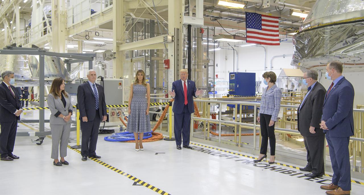 President Donald Trump, First Lady Melania Trump, Vice President Mike Pence, Second Lady Karen Pence, along with Kennedy Space Center Director Bob Cabana, left, Marillyn Hewson, Chief Executive Officer, Lockheed Martin, Mike Hawes, VP of Human Space Exploration and Orion Program Manager at Lockheed Martin Space, Vande NASA Administrator Jim Bridenstine, right, are seen by the Artemis I capsule during a tour of the Neil A. Armstrong Operations and Checkout Building following the departure of NASA astronauts Robert Behnken and Douglas Hurley for Launch Complex 39A to board a SpaceX Crew Dragon spacecraft for launch, Wednesday, May 27, 2020, at NASA’s Kennedy Space Center in Florida. NASA’s SpaceX Demo-2 mission is the first launch with astronauts of the SpaceX Crew Dragon spacecraft and Falcon 9 rocket to the International Space Station as part of the agency’s Commercial Crew Program. The test flight serves as an end-to-end demonstration of SpaceX’s crew transportation system. Today’s launch of Behnken and Hurley was scrubbed due to weather and is now scheduled for 3:22 p.m. EDT on Saturday, May 30, from Launch Complex 39A at the Kennedy Space Center. A new era of human spaceflight is set to begin as American astronauts once again launch on an American rocket from American soil to low-Earth orbit for the first time since the conclusion of the Space Shuttle Program in 2011.  Photo Credit: (NASA/Bill Ingalls)