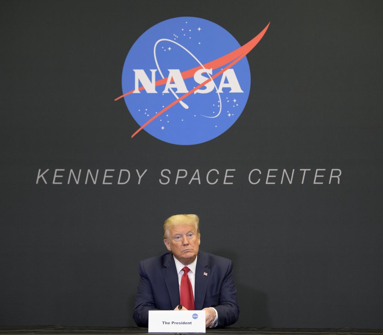 President Donald Trump participates in a SpaceX Demonstration Mission 2 Launch Briefing at the Neil A. Armstrong Operations and Checkout Building following the departure of NASA astronauts Robert Behnken and Douglas Hurley for Launch Complex 39A to board a SpaceX Crew Dragon spacecraft for launch, Wednesday, May 27, 2020, at NASA’s Kennedy Space Center in Florida. NASA’s SpaceX Demo-2 mission is the first launch with astronauts of the SpaceX Crew Dragon spacecraft and Falcon 9 rocket to the International Space Station as part of the agency’s Commercial Crew Program. The test flight serves as an end-to-end demonstration of SpaceX’s crew transportation system. Today’s launch of Behnken and Hurley was scrubbed due to weather and is now scheduled for 3:22 p.m. EDT on Saturday, May 30, from Launch Complex 39A at the Kennedy Space Center. A new era of human spaceflight is set to begin as American astronauts once again launch on an American rocket from American soil to low-Earth orbit for the first time since the conclusion of the Space Shuttle Program in 2011. Photo Credit: (NASA/Bill Ingalls)