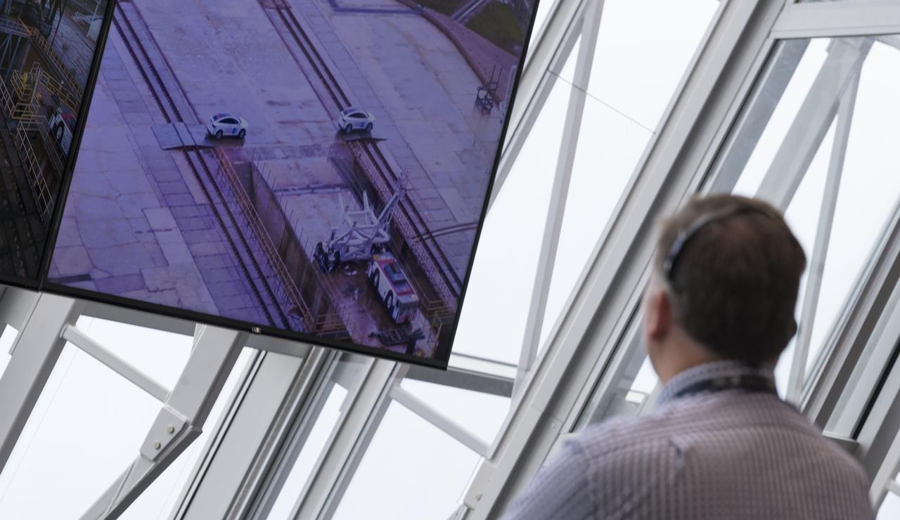 A monitor inside firing room four shows the arrival of the convoy carrying NASA astronauts Robert Behnken and Douglas Hurley at Launch Complex 39A during the countdown of the launch attempt of a SpaceX Falcon 9 rocket carrying the company's Crew Dragon spacecraft on NASA’s SpaceX Demo-2 mission, Wednesday, May 27, 2020, in the Launch Control Center at NASA’s Kennedy Space Center in Florida. NASA’s SpaceX Demo-2 mission is the first launch with astronauts of the SpaceX Crew Dragon spacecraft and Falcon 9 rocket to the International Space Station as part of the agency’s Commercial Crew Program. The test flight serves as an end-to-end demonstration of SpaceX’s crew transportation system. Today’s launch of Behnken and Hurley was scrubbed due to weather and is now scheduled for 3:22 p.m. EDT on Saturday, May 30, from Launch Complex 39A at the Kennedy Space Center. A new era of human spaceflight is set to begin as American astronauts once again launch on an American rocket from American soil to low-Earth orbit for the first time since the conclusion of the Space Shuttle Program in 2011. Photo Credit: (NASA/Joel Kowsky)