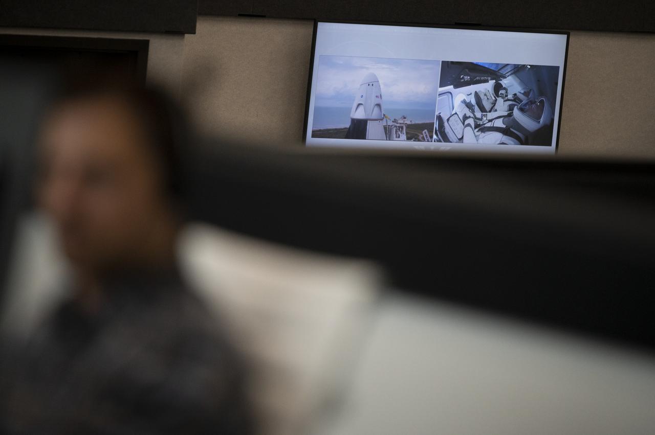 A monitor in firing room four shows views NASA astronauts Douglas Hurley and Robert Behnken onboard SpaceX’s Crew Dragon spacecraft during a launch attempt of NASA’s SpaceX Demo-2 mission, Wednesday, May 27, 2020, in firing room four of the Launch Control Center at NASA’s Kennedy Space Center in Florida. NASA’s SpaceX Demo-2 mission is the first launch with astronauts of the SpaceX Crew Dragon spacecraft and Falcon 9 rocket to the International Space Station as part of the agency’s Commercial Crew Program. The test flight serves as an end-to-end demonstration of SpaceX’s crew transportation system. Today’s launch of Behnken and Hurley was scrubbed due to weather and is now scheduled for 3:22 p.m. EDT on Saturday, May 30, from Launch Complex 39A at the Kennedy Space Center. A new era of human spaceflight is set to begin as American astronauts once again launch on an American rocket from American soil to low-Earth orbit for the first time since the conclusion of the Space Shuttle Program in 2011. Photo Credit: (NASA/Joel Kowsky)