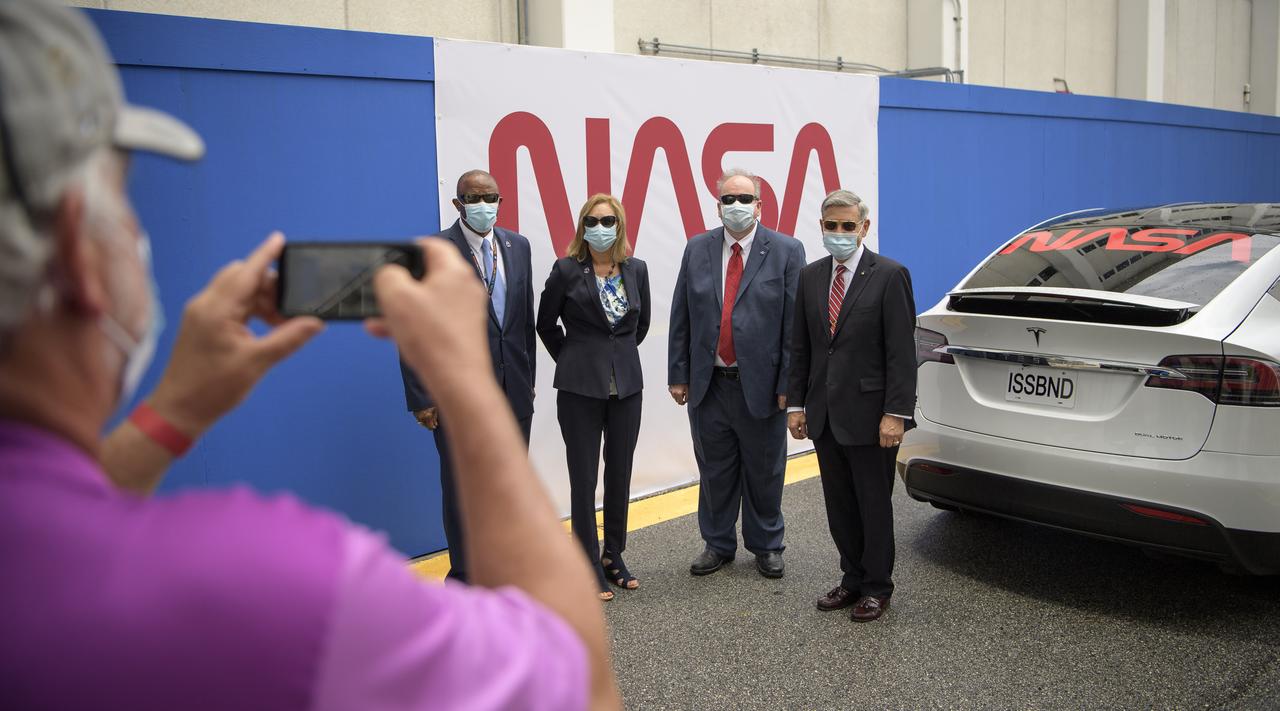 NASA Kennedy Space Center Associate Technical Director Kelvin Manning, left, Kennedy Space Center Deputy Director Janet Petro, Kennedy Space Center Associate Director, Management, Burt Summerfield, and Kennedy Space Center Director Bob Cabana, right, pose for a group photograph as they wait to see NASA astronauts Douglas Hurley and Robert Behnken depart the Neil A. Armstrong Operations and Checkout Building for Launch Complex 39A to board the SpaceX Crew Dragon spacecraft for the Demo-2 mission launch, Wednesday, May 27, 2020, at NASA’s Kennedy Space Center in Florida. NASA’s SpaceX Demo-2 mission is the first launch with astronauts of the SpaceX Crew Dragon spacecraft and Falcon 9 rocket to the International Space Station as part of the agency’s Commercial Crew Program. The test flight serves as an end-to-end demonstration of SpaceX’s crew transportation system. Today’s launch of Behnken and Hurley was scrubbed due to weather and is now scheduled for 3:22 p.m. EDT on Saturday, May 30, from Launch Complex 39A at the Kennedy Space Center. A new era of human spaceflight is set to begin as American astronauts once again launch on an American rocket from American soil to low-Earth orbit for the first time since the conclusion of the Space Shuttle Program in 2011. Photo Credit: (NASA/Bill Ingalls)