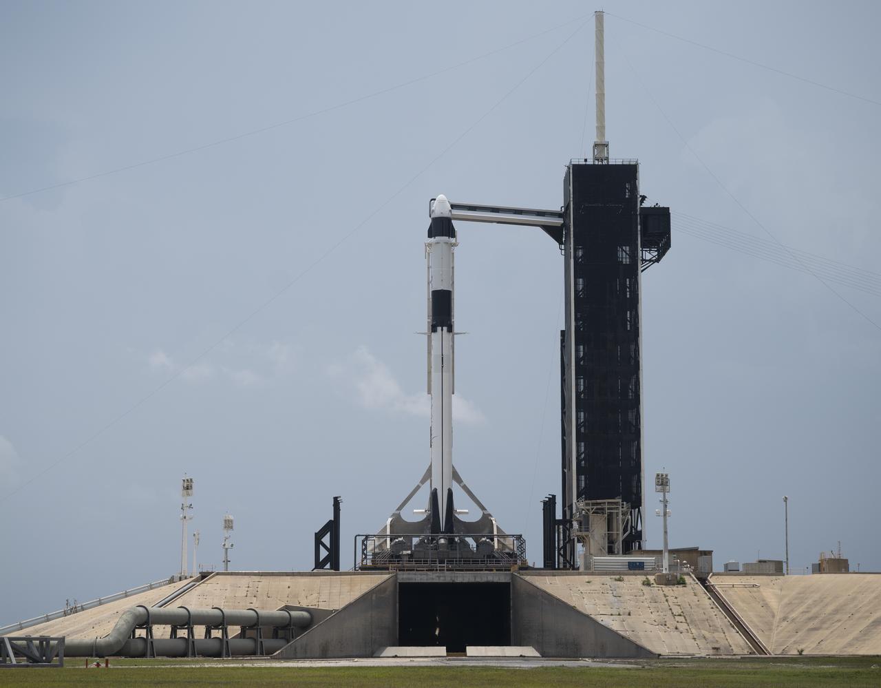 A SpaceX Falcon 9 rocket with the company's Crew Dragon spacecraft onboard is seen on the launch pad at Launch Complex 39A as preparations continue for the Demo-2 mission, Thursday, May 28, 2020, at NASA’s Kennedy Space Center in Florida. NASA’s SpaceX Demo-2 mission is the first launch with astronauts of the SpaceX Crew Dragon spacecraft and Falcon 9 rocket to the International Space Station as part of the agency’s Commercial Crew Program. The test flight serves as an end-to-end demonstration of SpaceX’s crew transportation system. Robert Behnken and Douglas Hurley are scheduled to launch at 3:22 p.m. EDT on Saturday, May 30, from Launch Complex 39A at the Kennedy Space Center. A new era of human spaceflight is set to begin as American astronauts once again launch on an American rocket from American soil to low-Earth orbit for the first time since the conclusion of the Space Shuttle Program in 2011. Photo Credit: (NASA/Joel Kowsky)